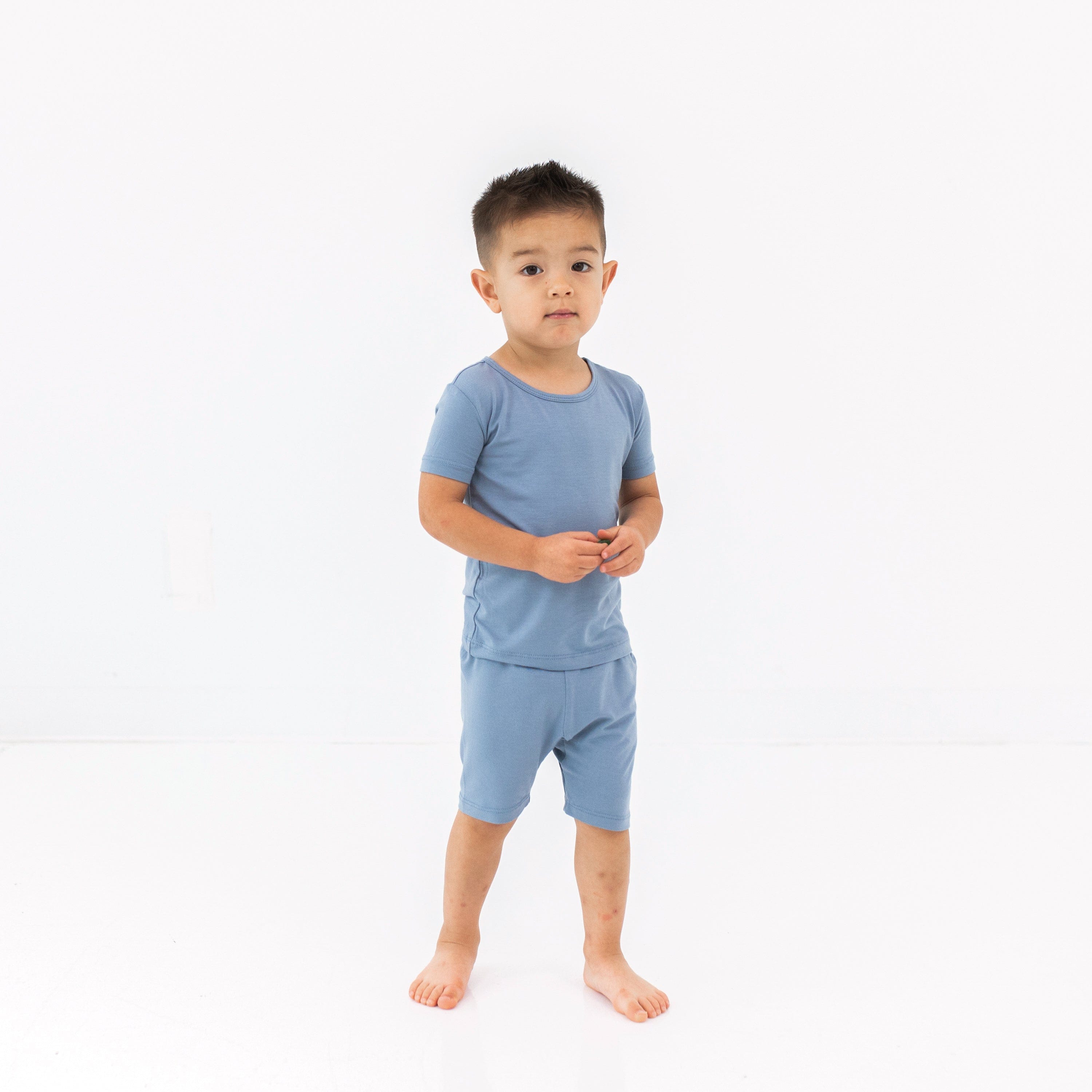 Child wearing the two piece Short Sleeve Toddler Pajama Set in Slate