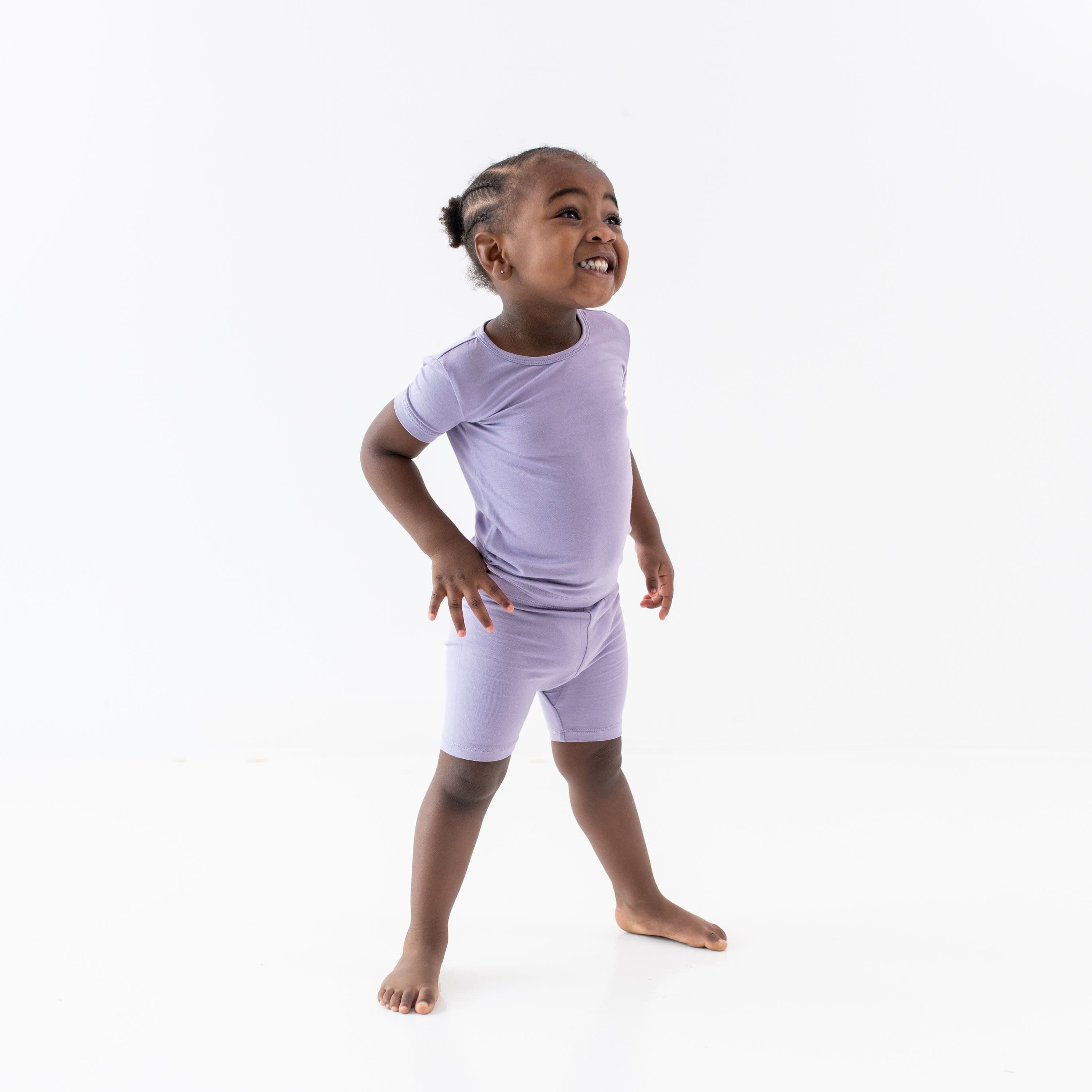 Child wearing Kyte Baby Short Sleeve Pajamas in Taro