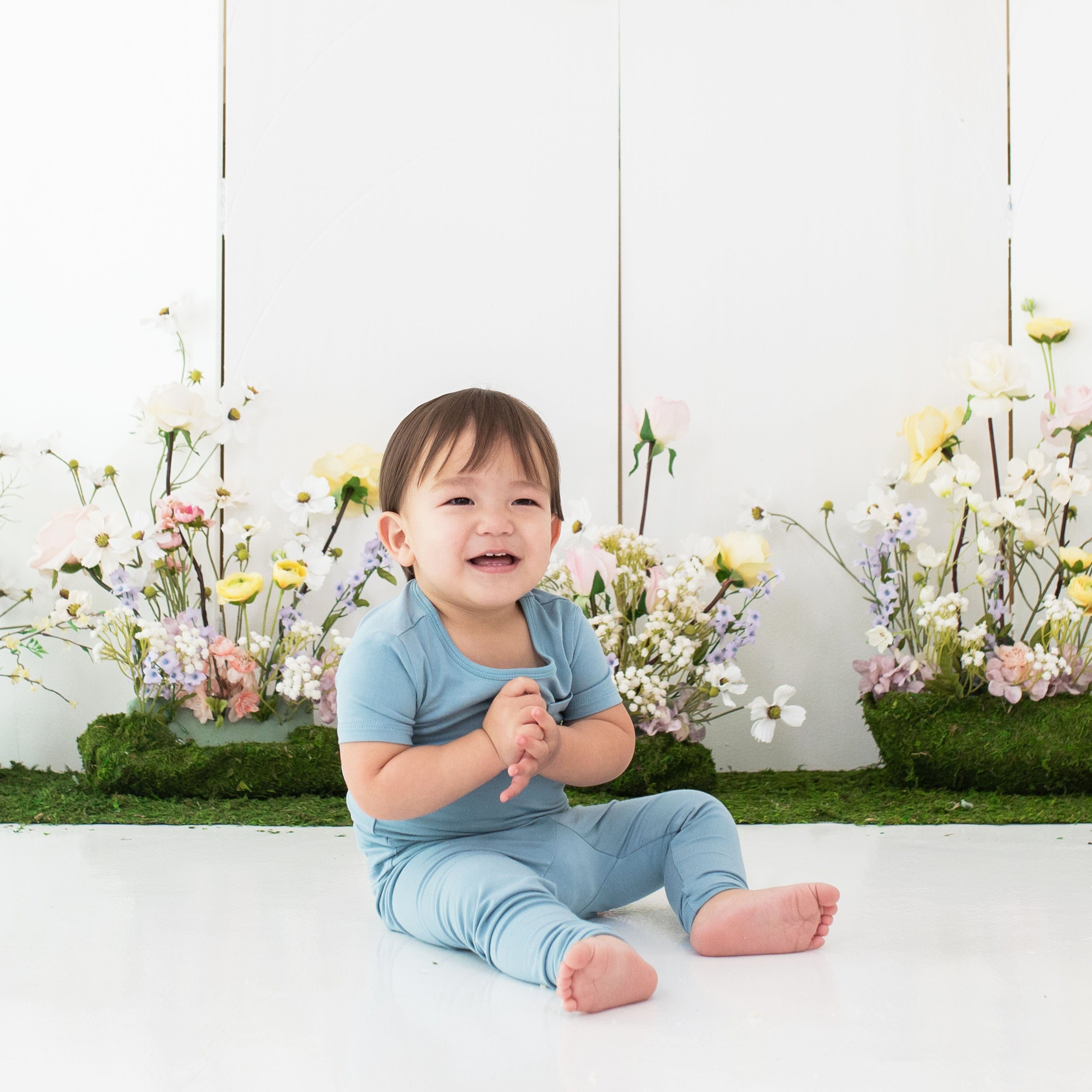 Toddler wearing Kyte Baby Short Sleeve with Pants Pajamas in Dusty Blue