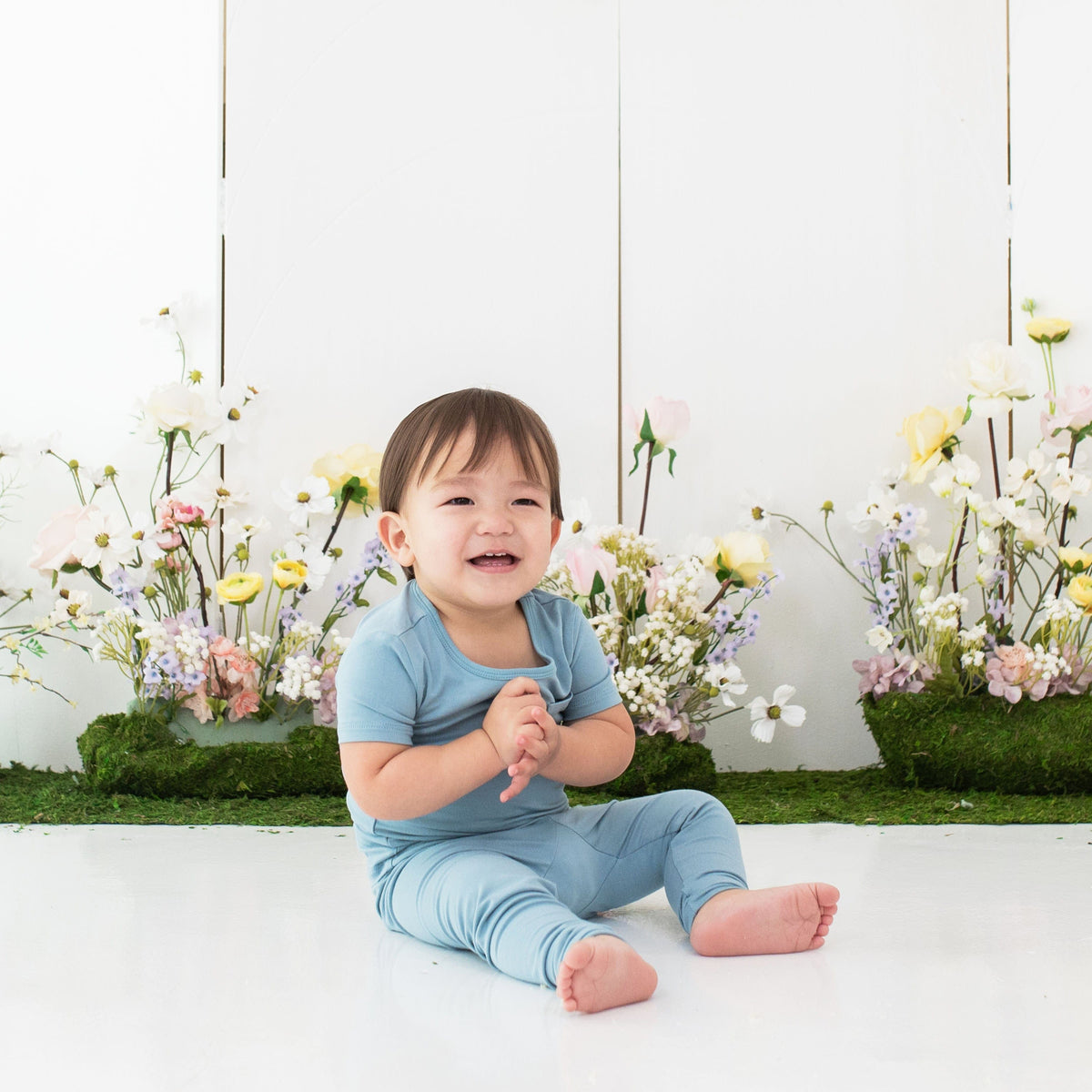 Toddler wearing Kyte Baby Short Sleeve with Pants Pajamas in Dusty Blue