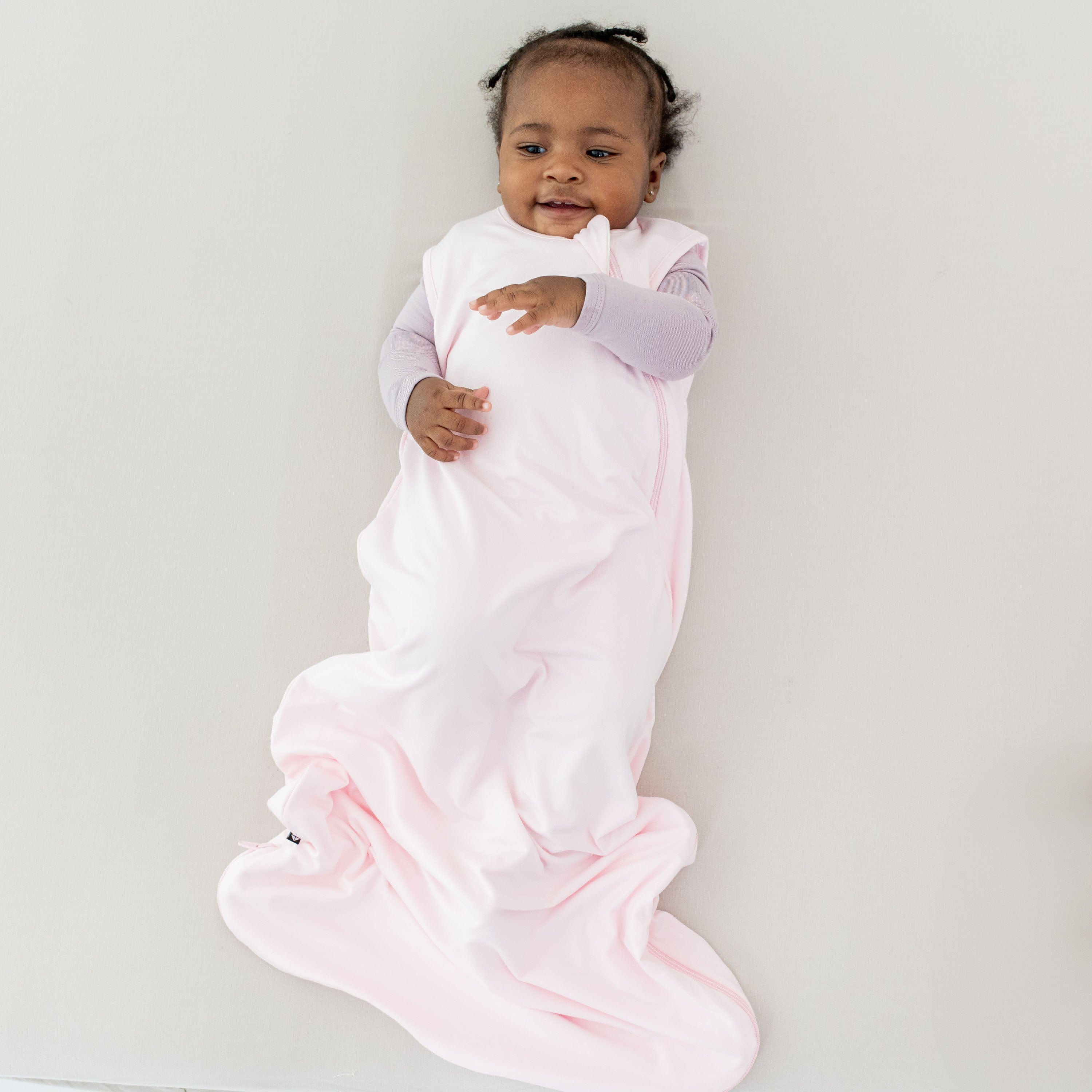 Baby wearing Kyte Baby bamboo Sleep Bag TOG 0.5 in Sakura pink