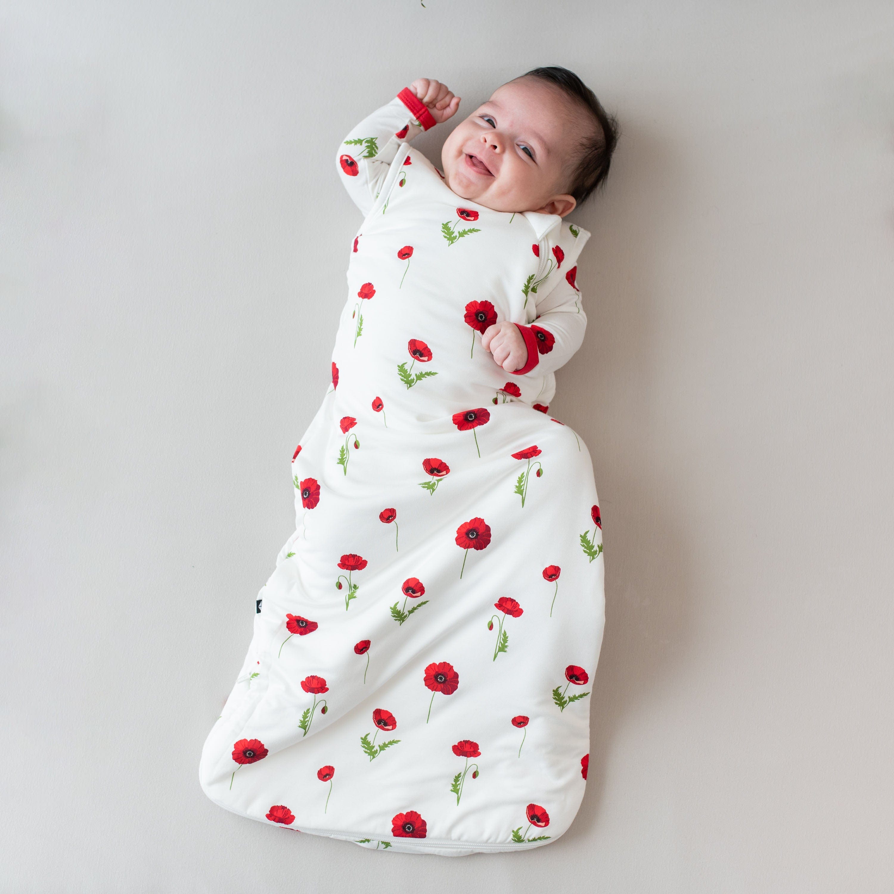 Baby wearing Kyte Baby bamboo Sleep Bag in Cloud Poppies 1.0