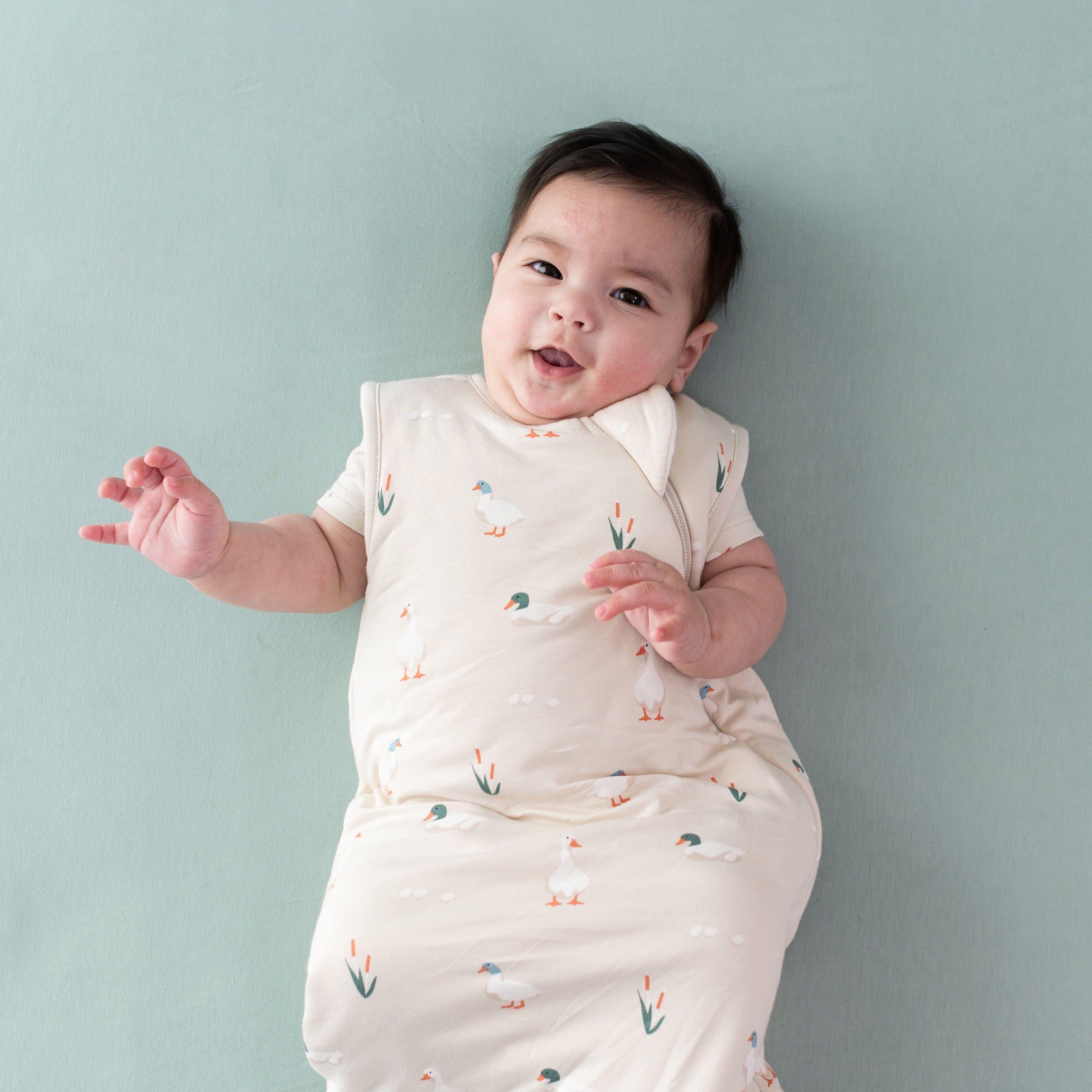 Infant wearing Kyte Baby Sleep Bag in Duck 1.0