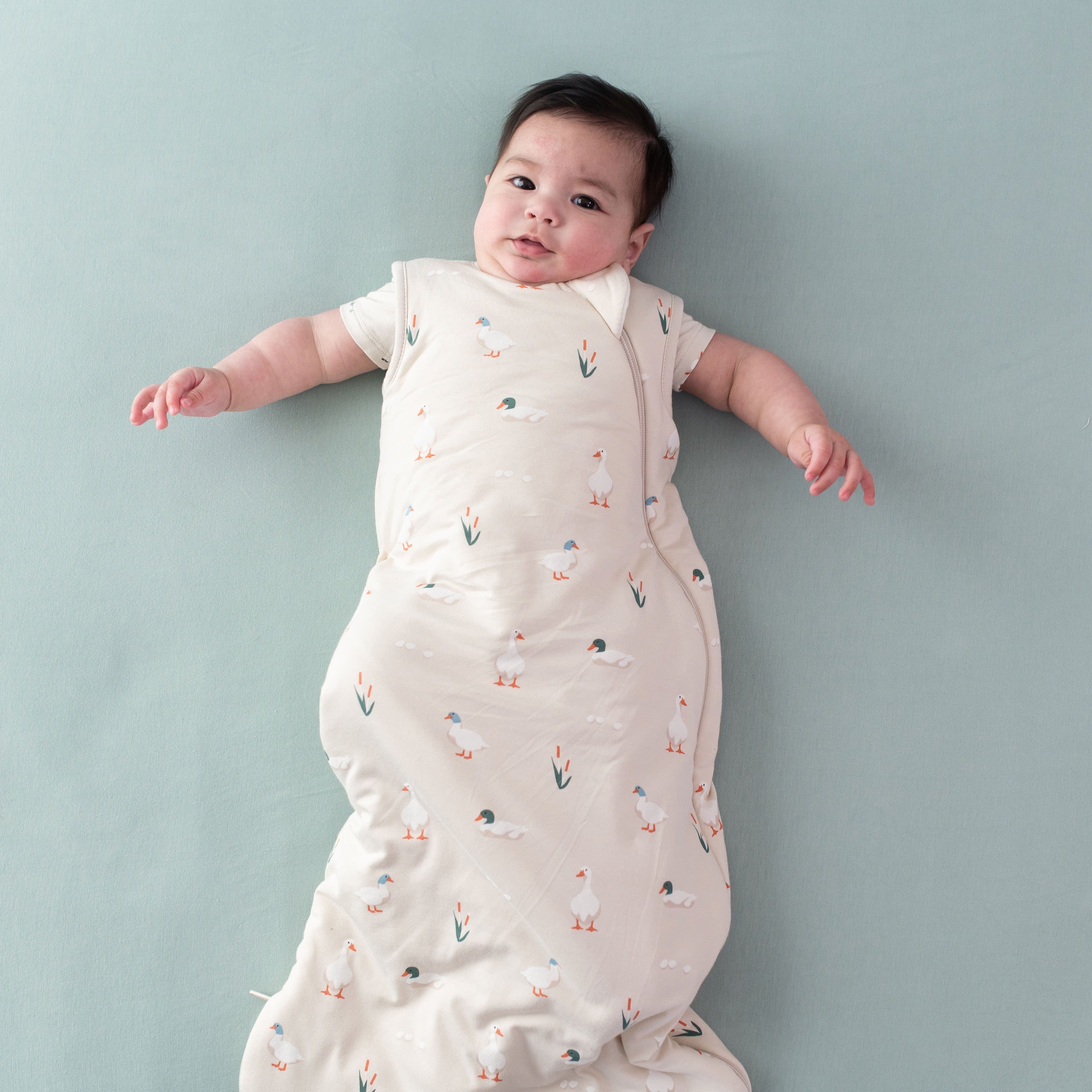 Baby wearing Kyte Baby bamboo Sleep Bag in Duck 1.0