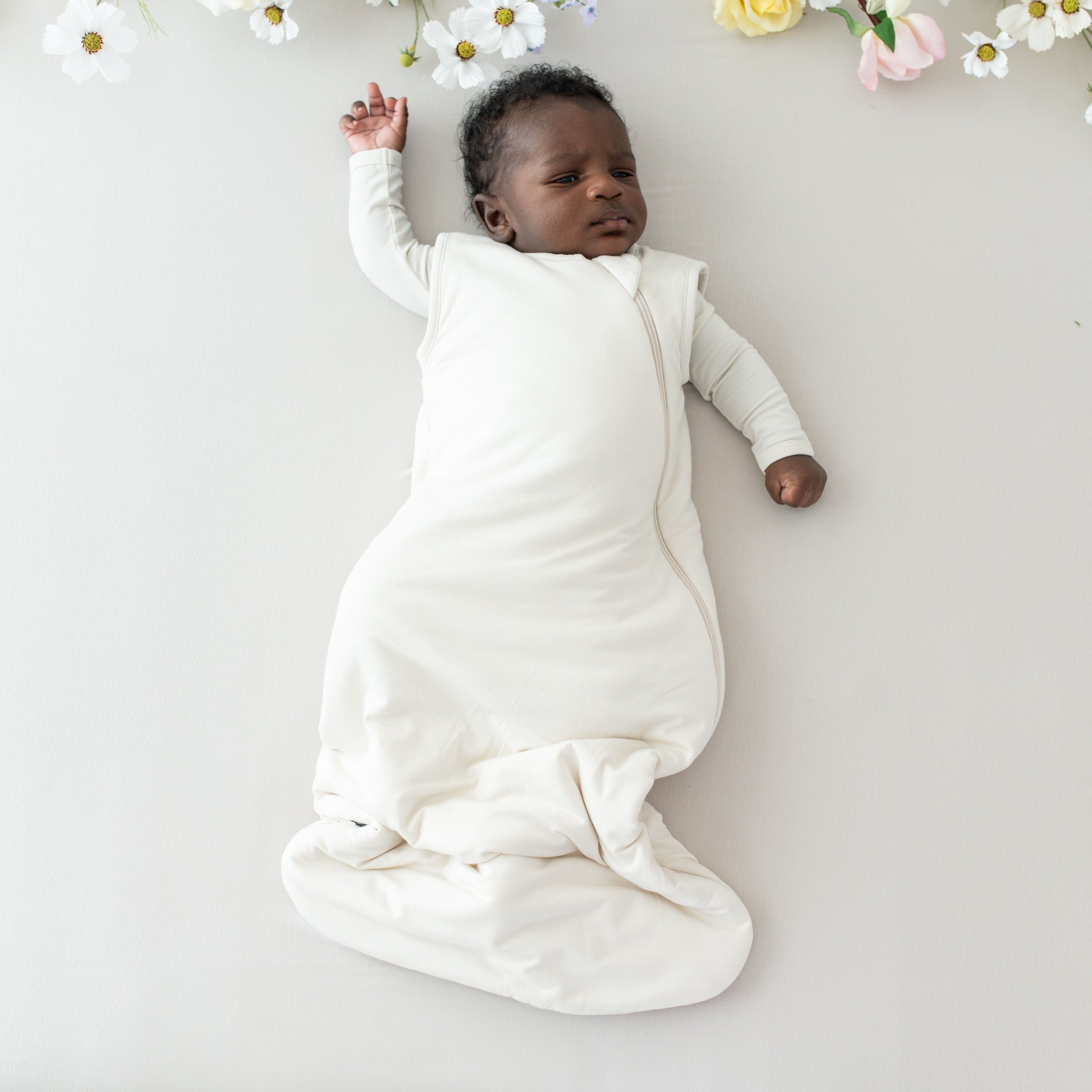 Baby wearing Kyte Baby bamboo wearable blanket Sleep Bag in Ecru 1.0