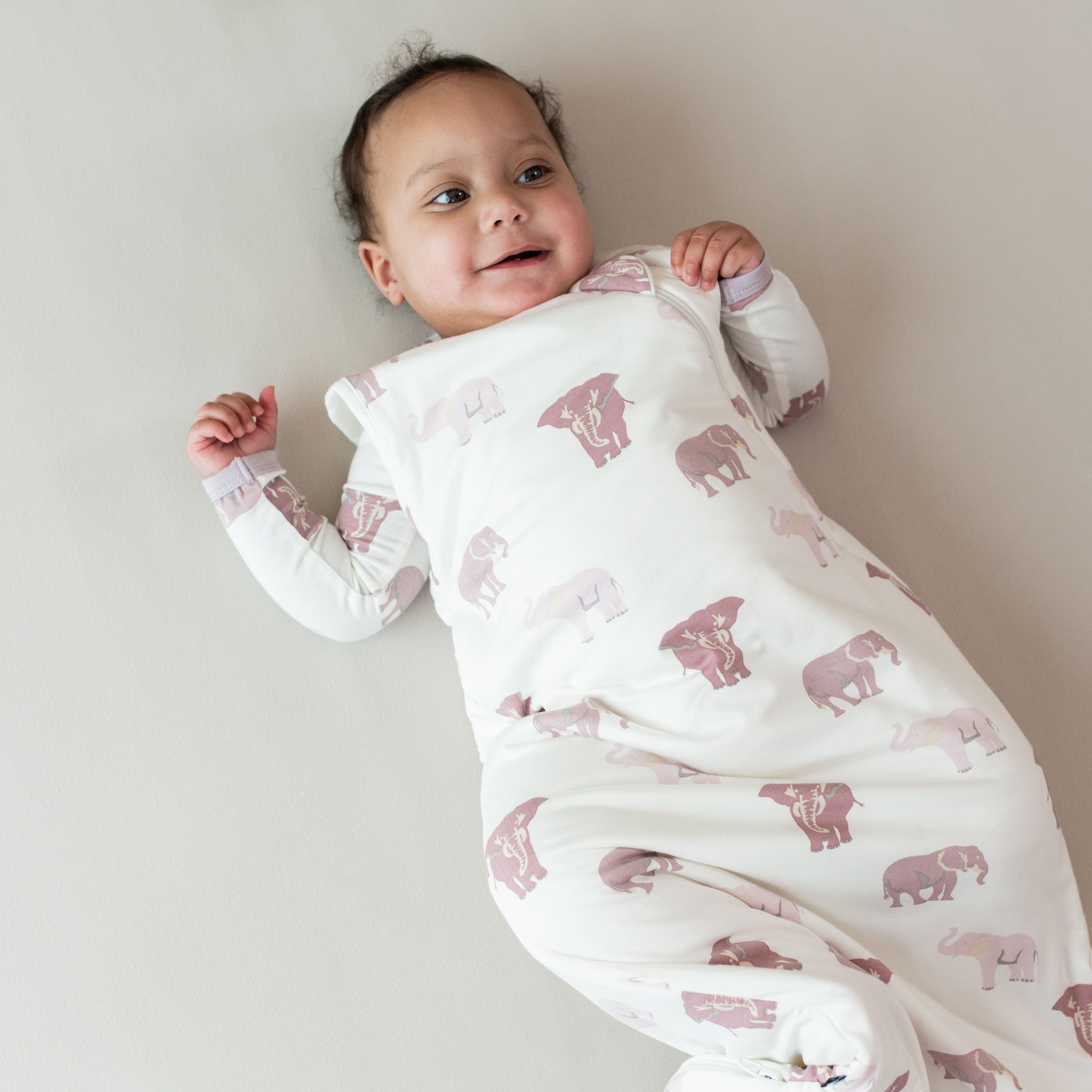 Baby wearing Kyte Baby bamboo TOG 1.0 Sleep Bag in Elephant