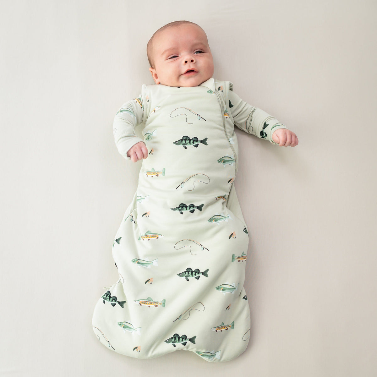 Infant wearing Kyte Baby Sleep Bag in Fishing 1.0
