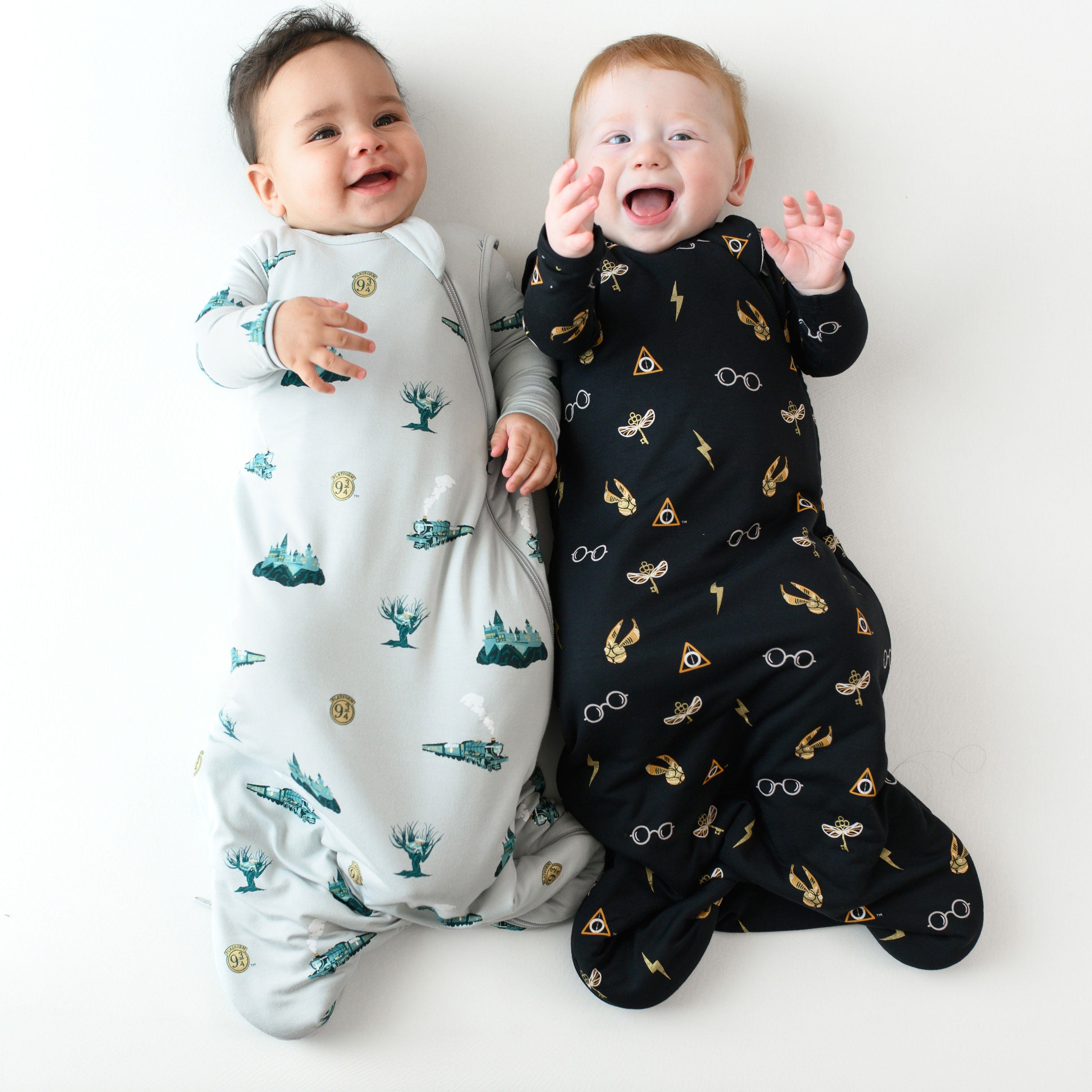 Two infant models wearing Journey and Midnight Icon 1.0 Sleep Bags