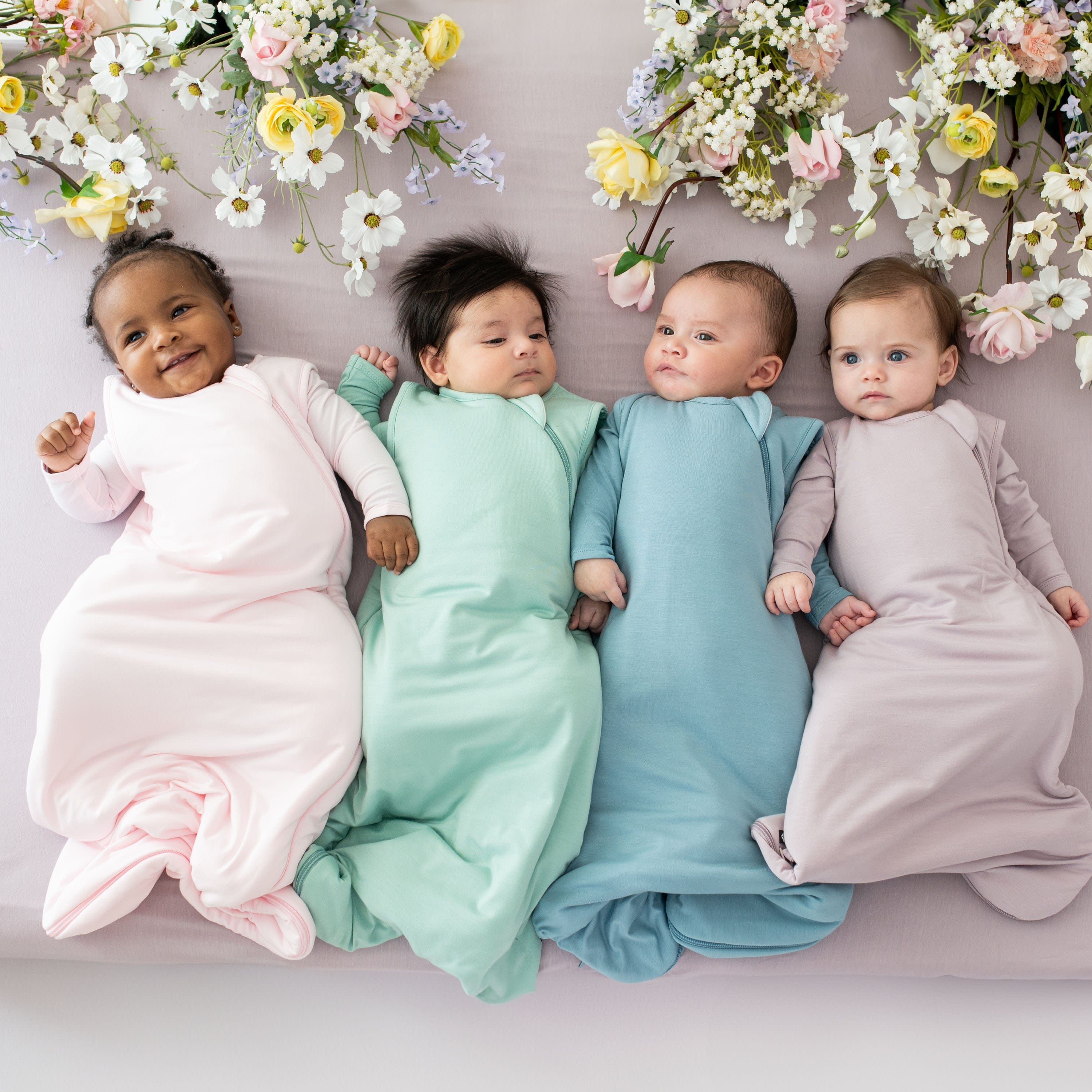 Babies wearing Kyte Baby 1.0 TOG sleep bags in Spring 2024 colors