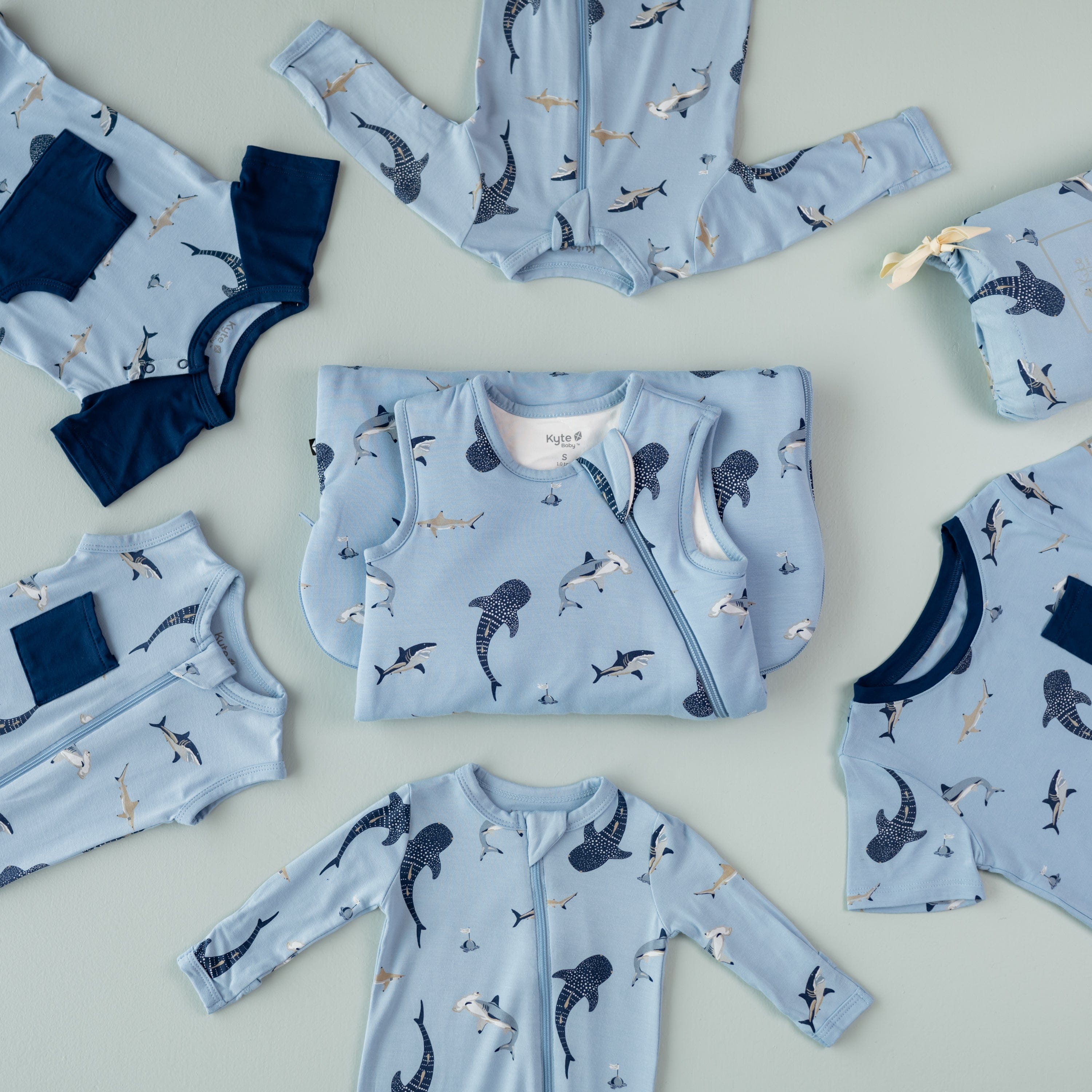Kyte Baby bamboo sleepwear and clothing in Stream Shark pattern flat lay