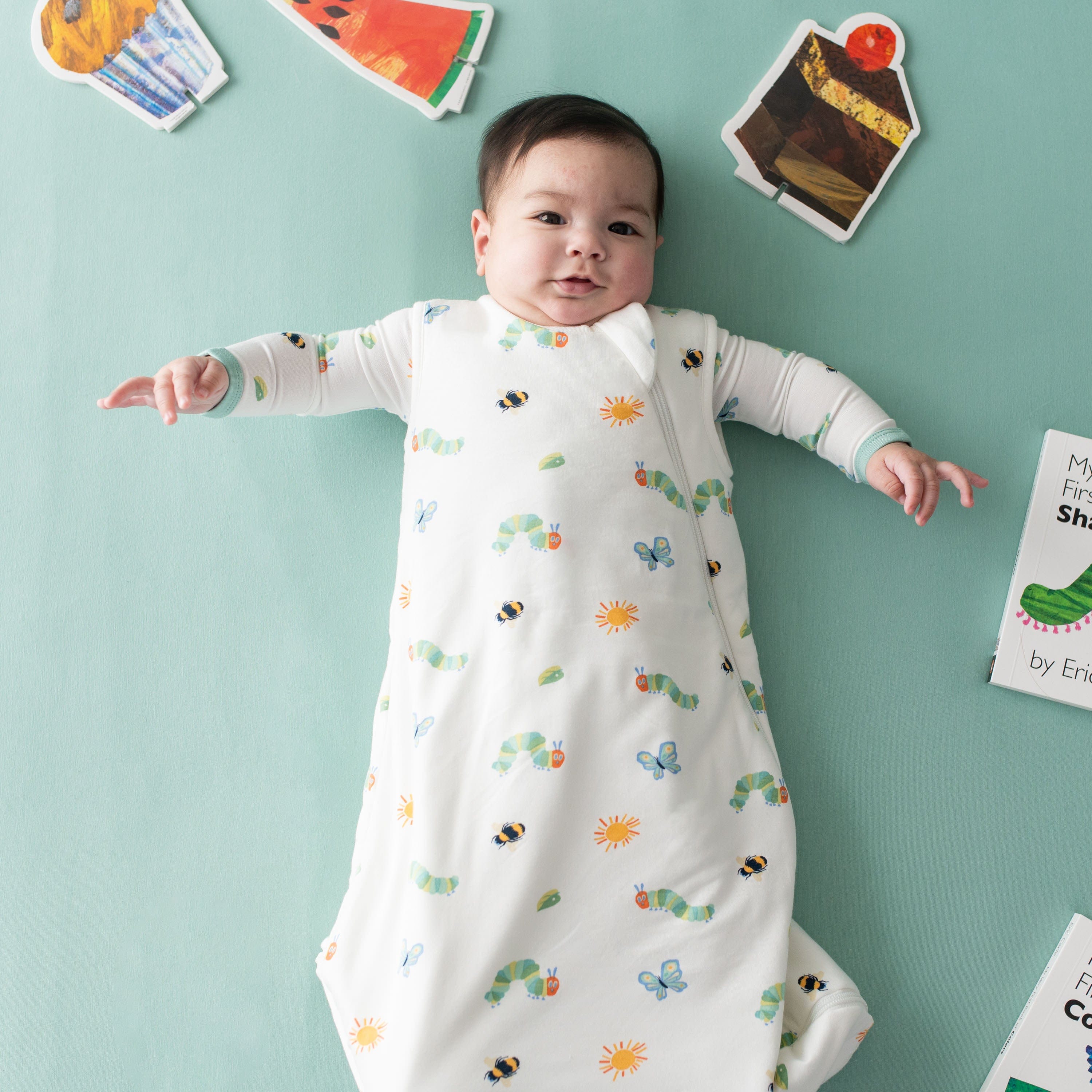 Baby wearing Kyte Baby bamboo TOG 1.0 Sleep Bag in The Very Hungry Caterpillar™ and Friends