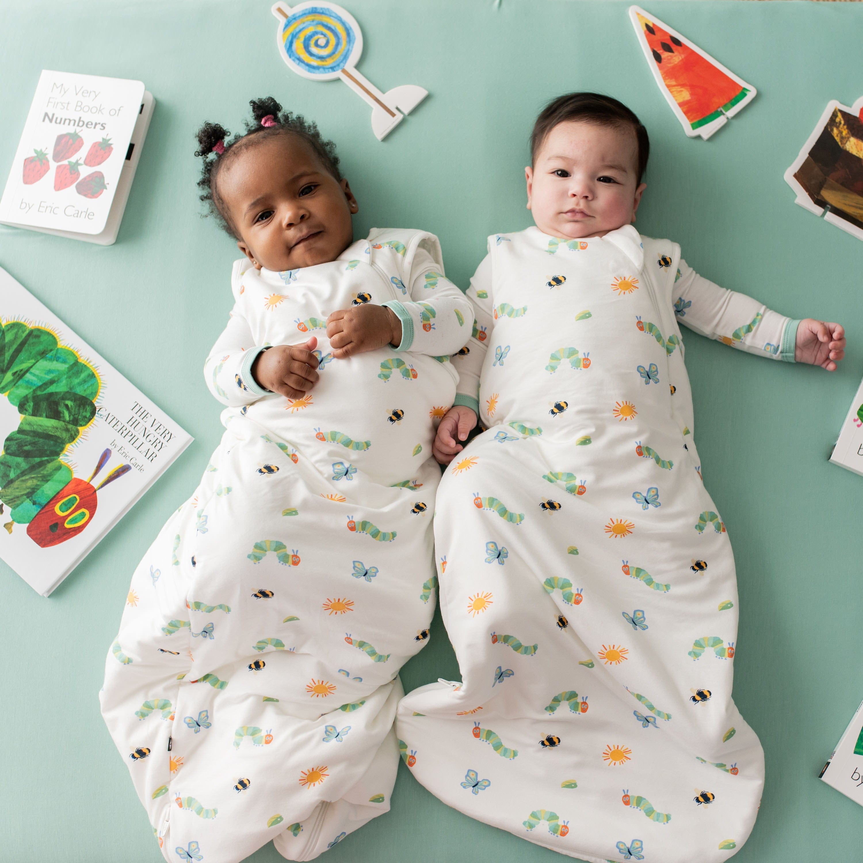 Two babies wearing Kyte Baby sleep bags TOG 1.0 in The Very Hungry Caterpillar™ and Friends