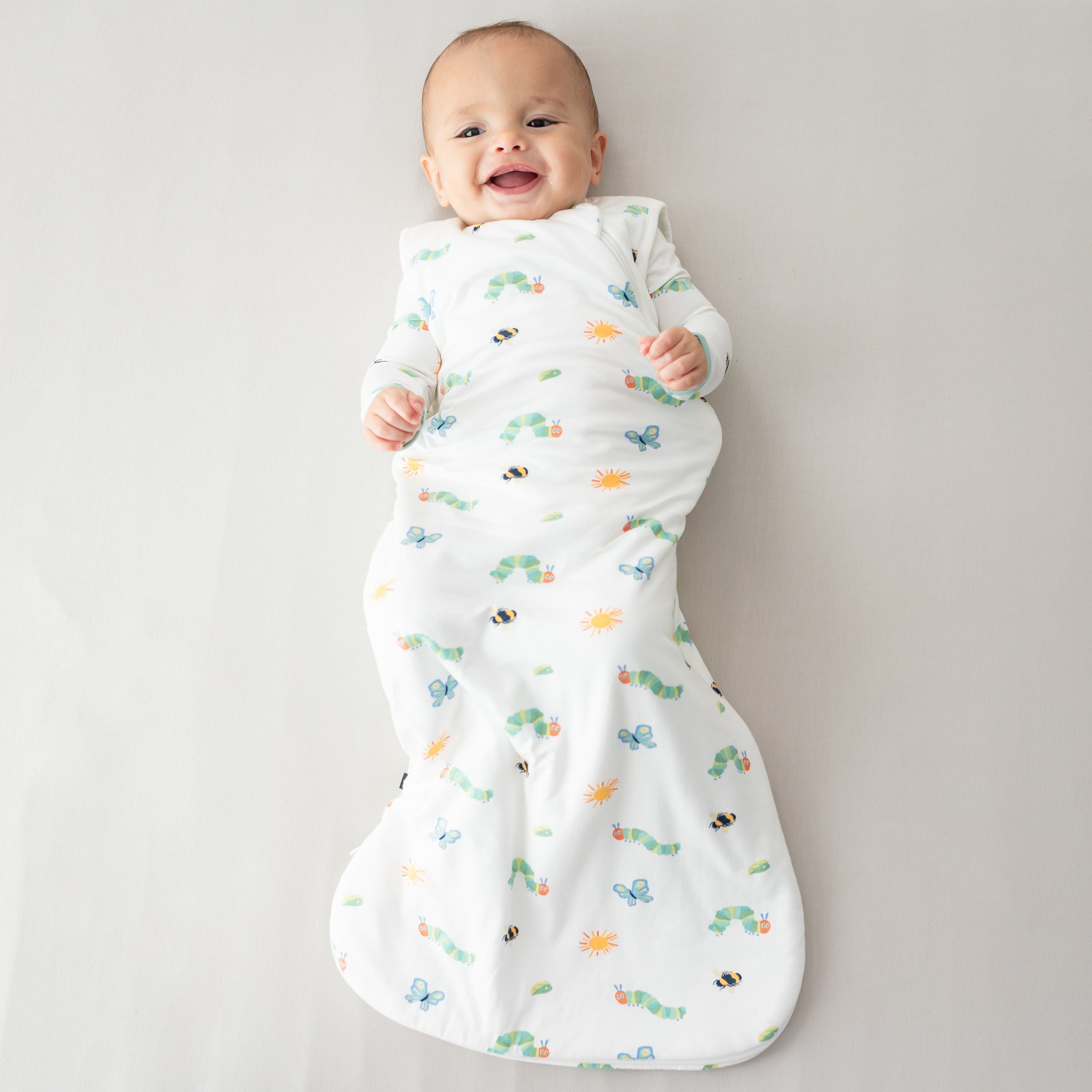 Infant wearing Kyte Baby Sleep Bag in The Very Hungry Caterpillar™ and Friends 1.0