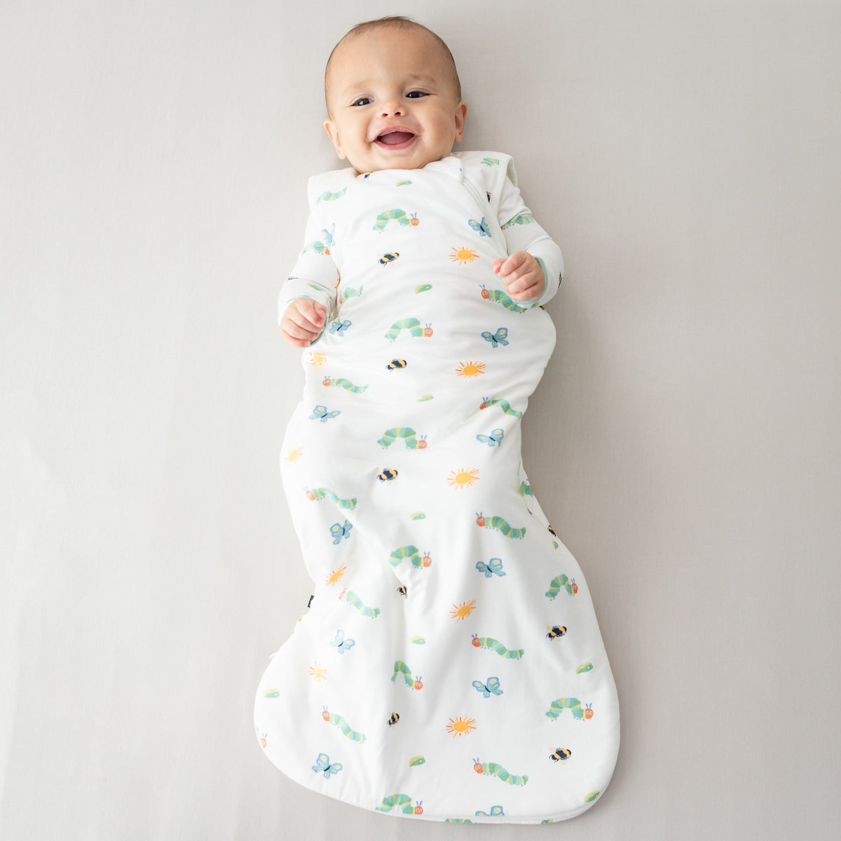 Infant wearing Kyte Baby Sleep Bag in The Very Hungry Caterpillar™ and Friends 1.0