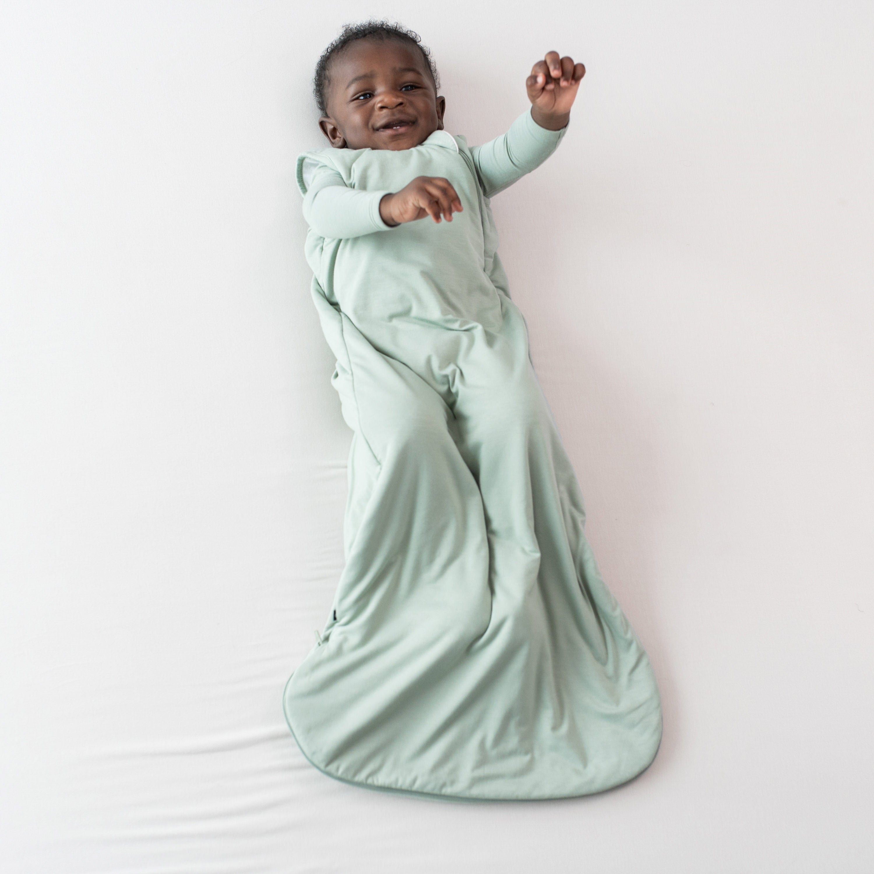 Infant wearing Kyte Baby bamboo Sleep Bag in Thyme 1.0