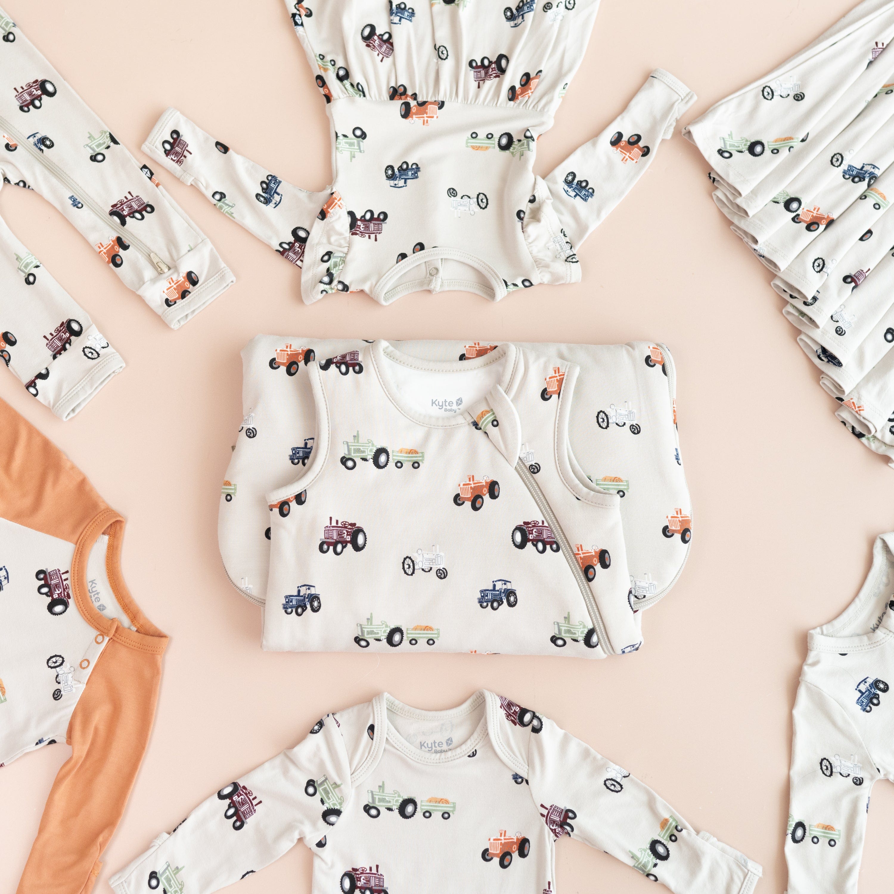 Flat lay of Kyte Baby bamboo clothing and sleep bags in Tractor