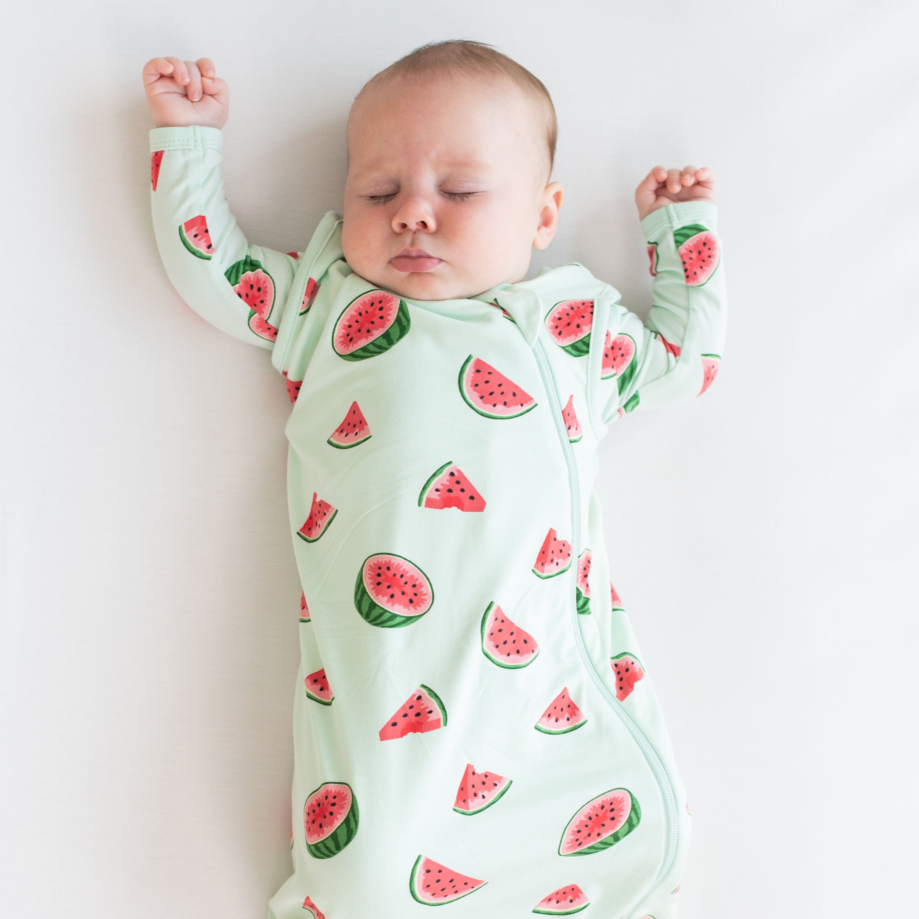 Infant wearing Kyte Baby Sleep Bag in Watermelon 1.0 TOG