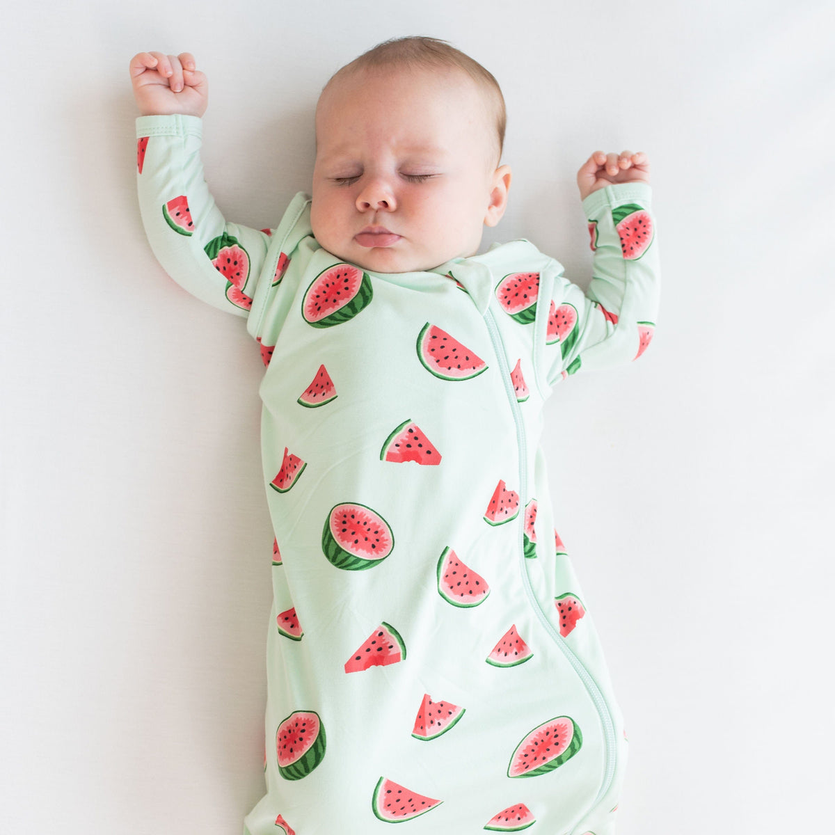 Infant wearing Kyte Baby Sleep Bag in Watermelon 1.0 TOG