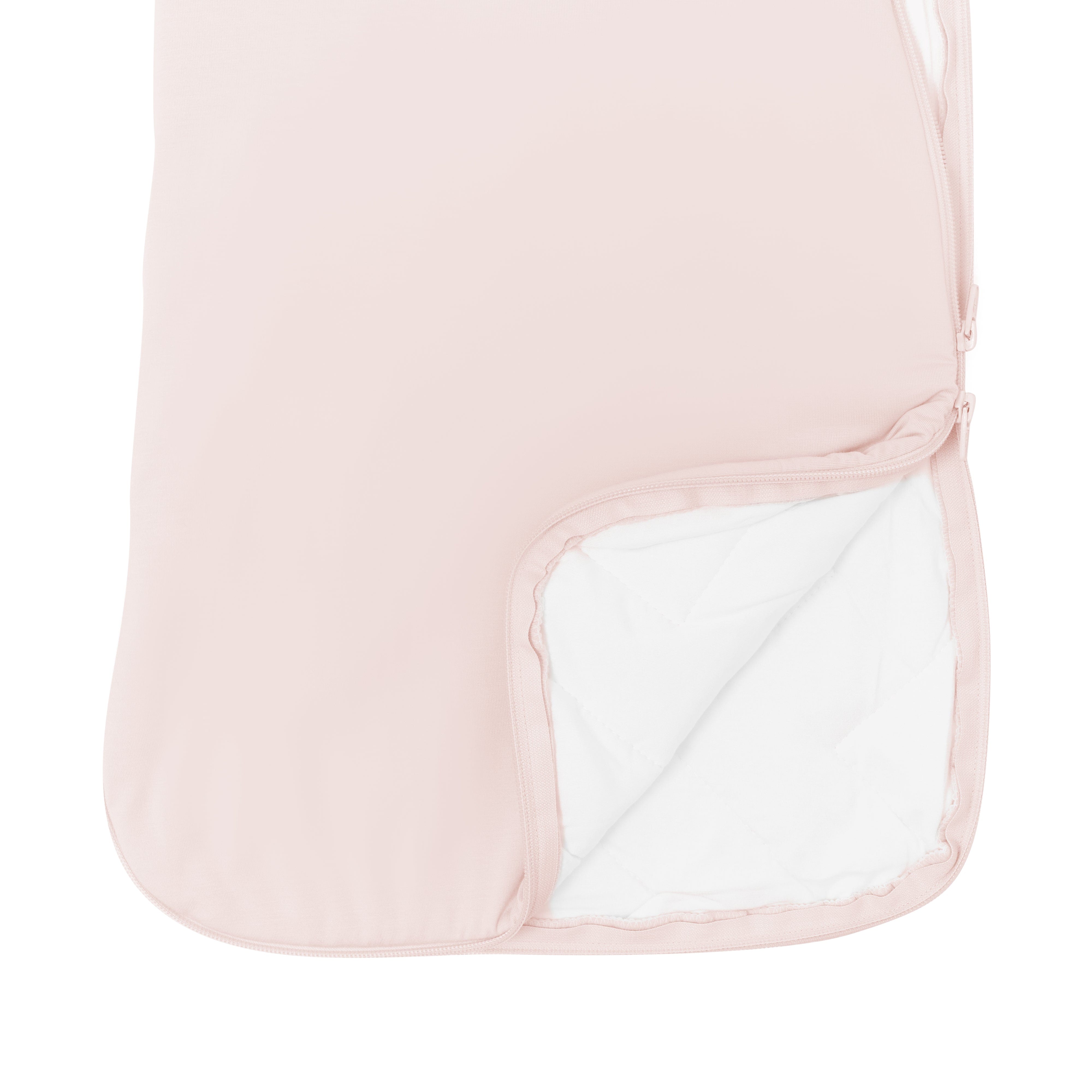 Close up of unzipped dual zipper on Kyte Baby Sleep Bag in Blush 2.5