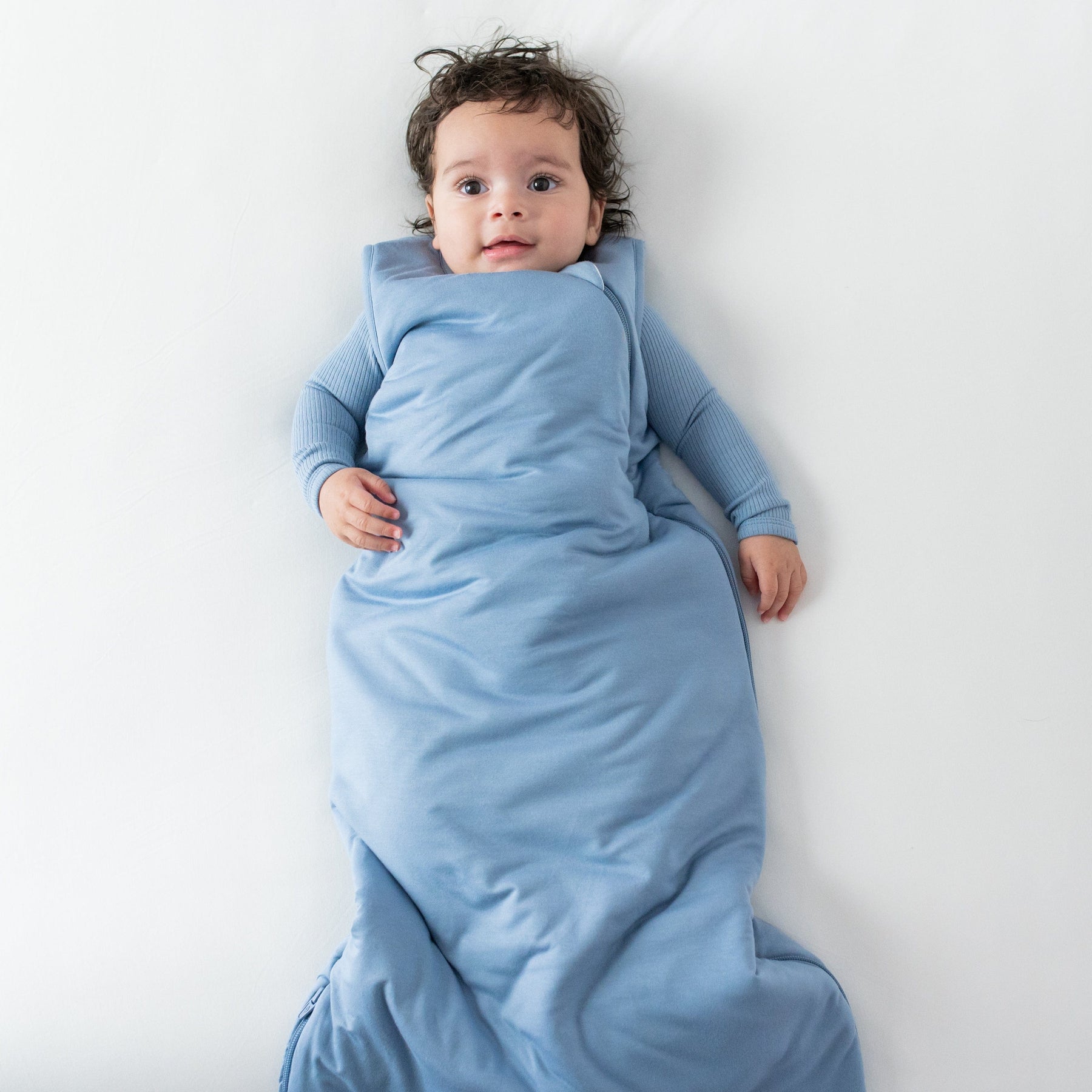 Baby wearing Kyte Baby Sleep Bag TOG 2.5 in Slate blue