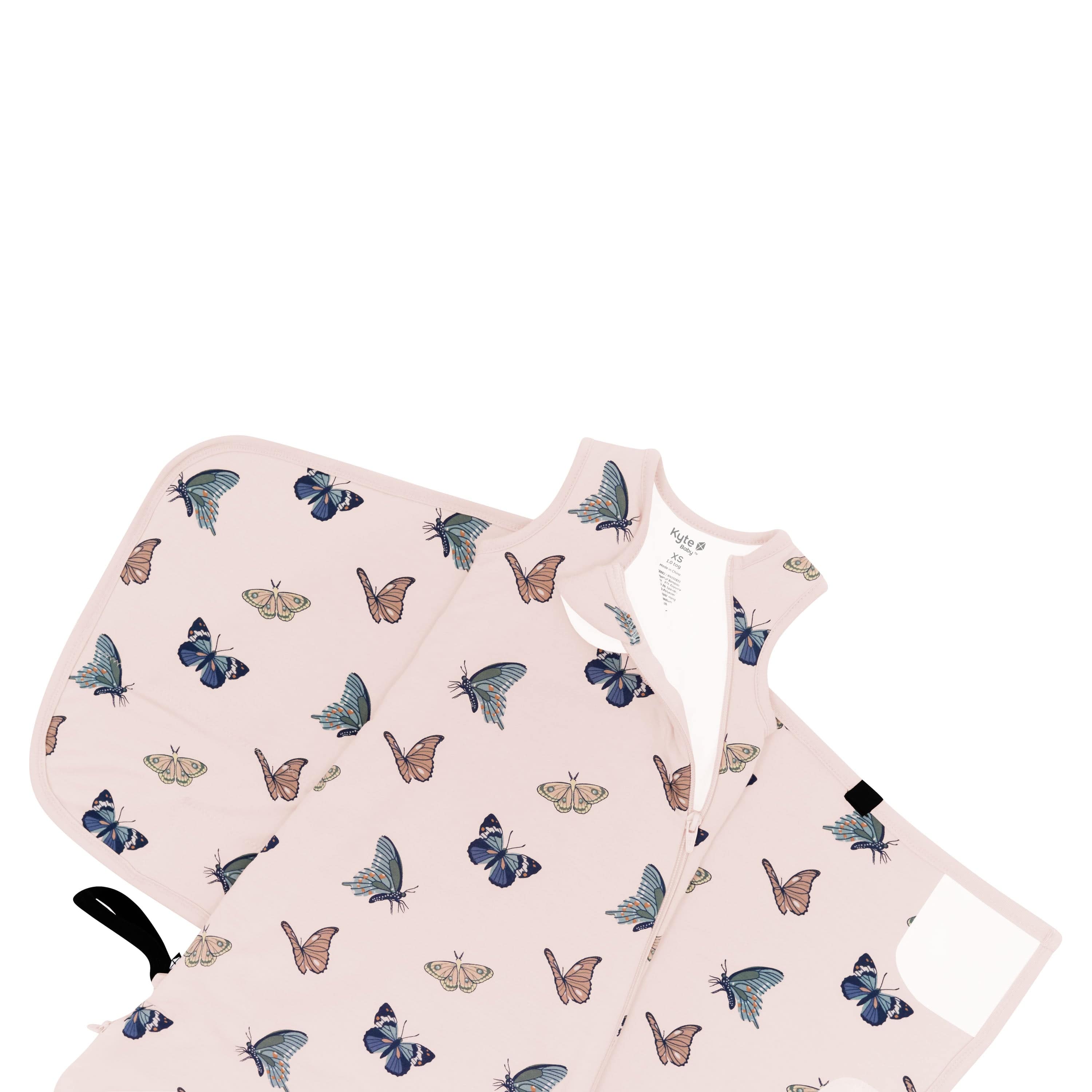 Sleep Bag Swaddler in Blush Butterfly 1.0 shown unswaddled and top zipper unzipped