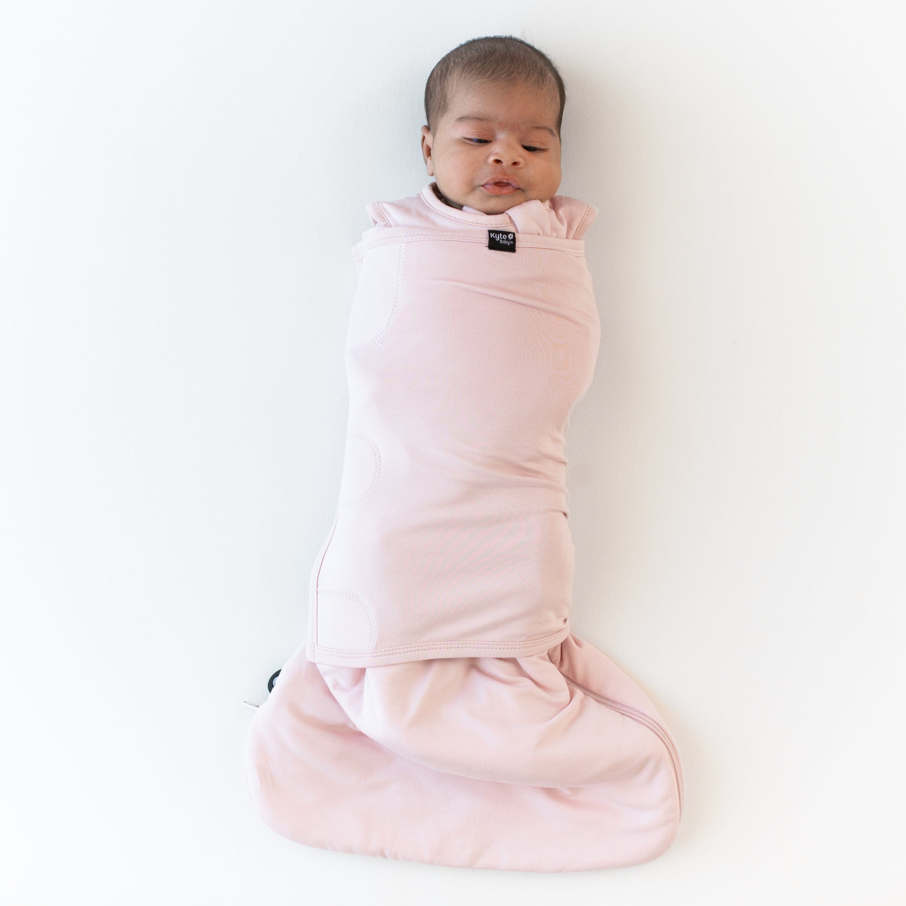 Baby swaddled in the Sleep Bag Swaddler in Blush 1.0