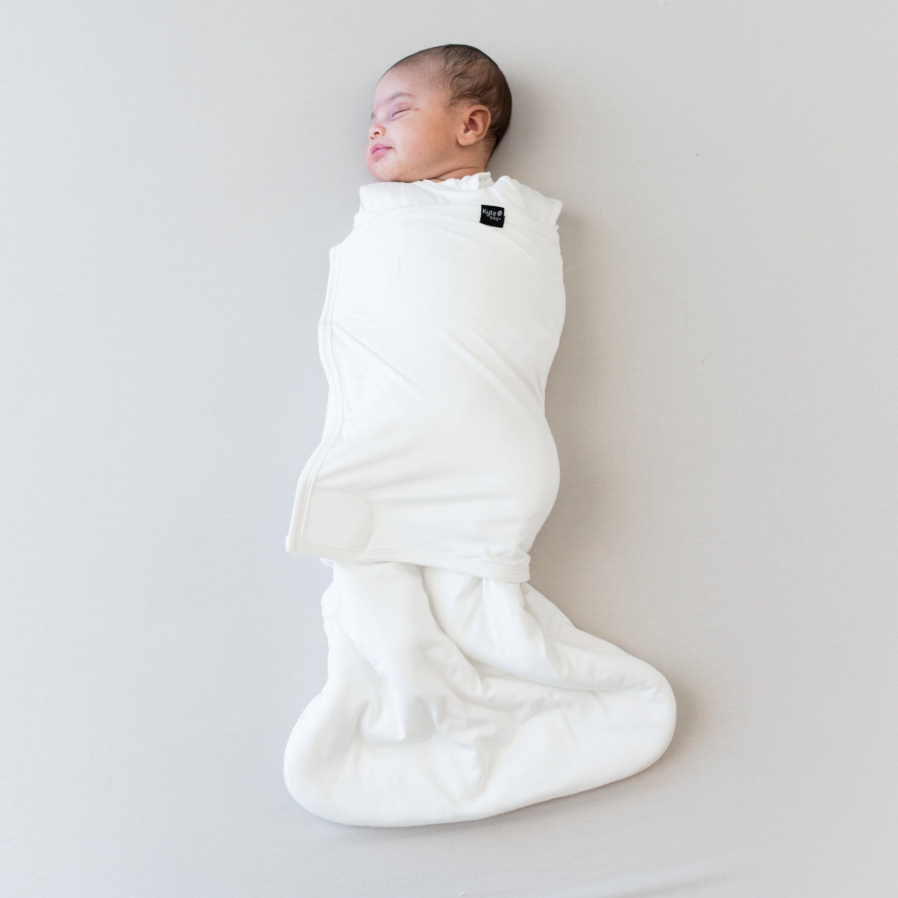 Sleeping baby swaddled in the Sleep Bag Swaddler in Cloud 1.0