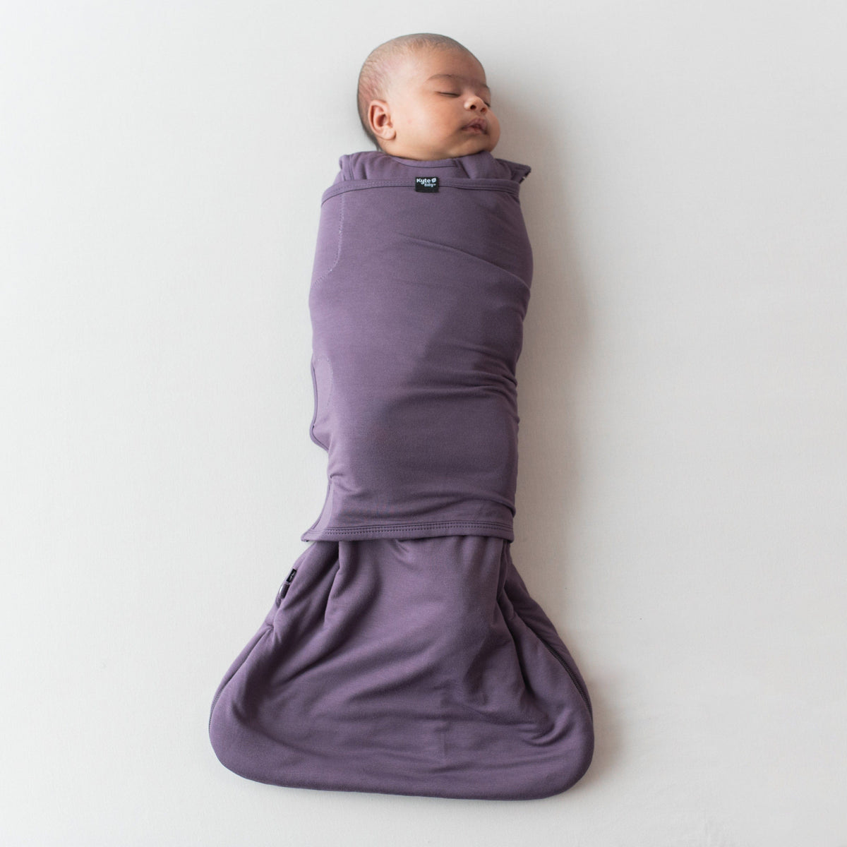 Infant swaddled in the Sleep Bag Swaddler in Currant 1.0