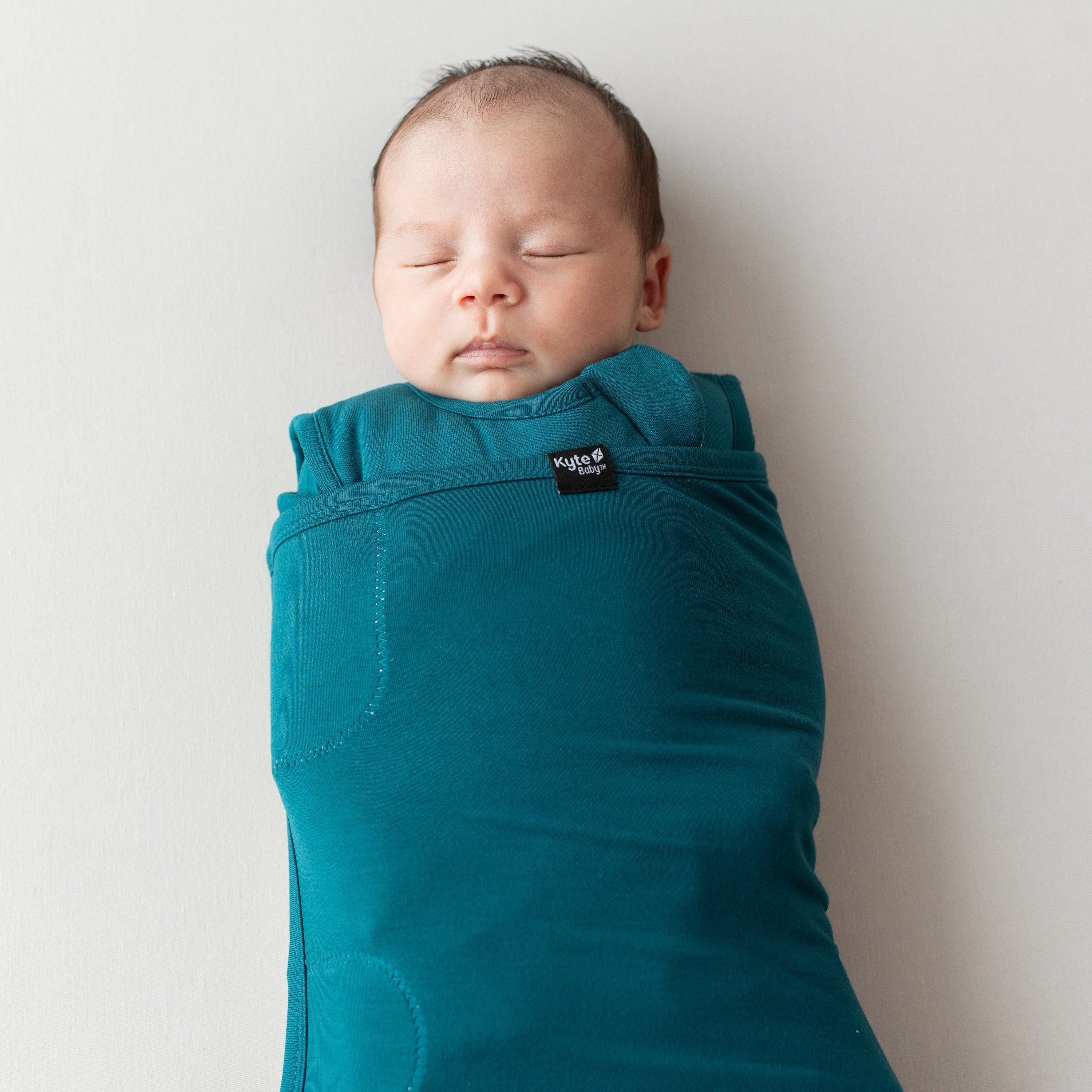 Sleeping baby swaddled in Sleep Bag Swaddler in Loch 1.0