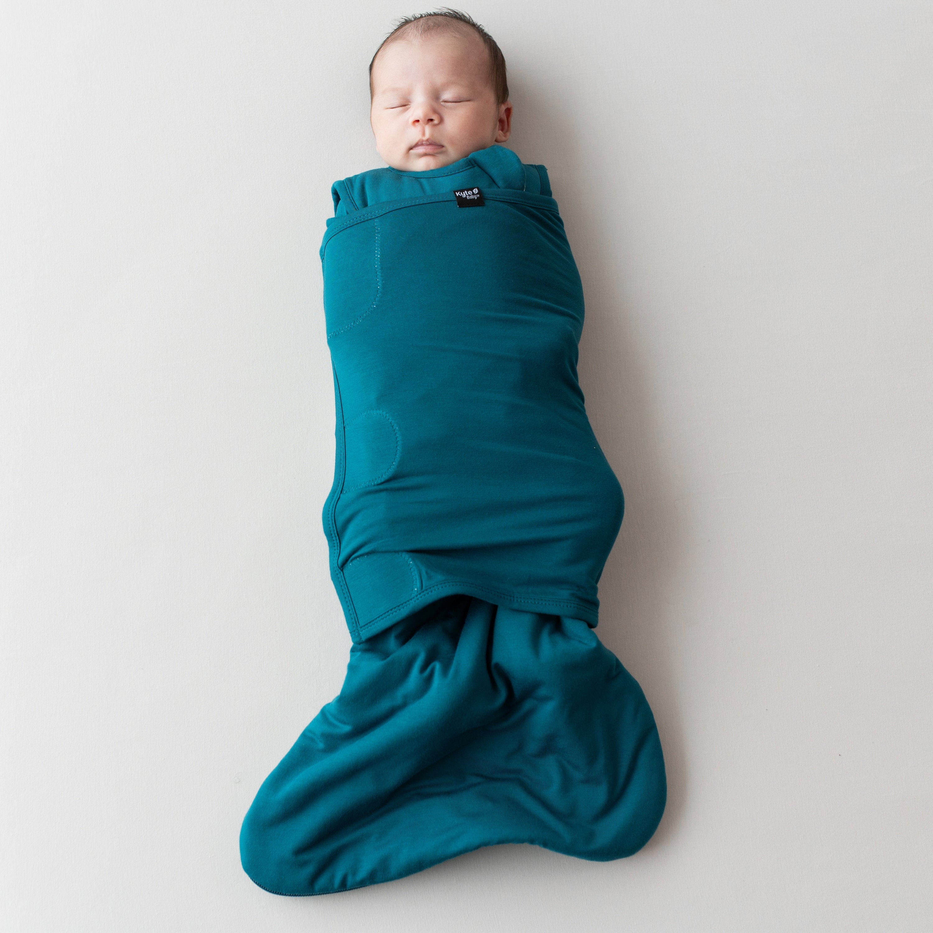 Sleeping baby swaddled in Sleep Bag Swaddler in Loch 1.0