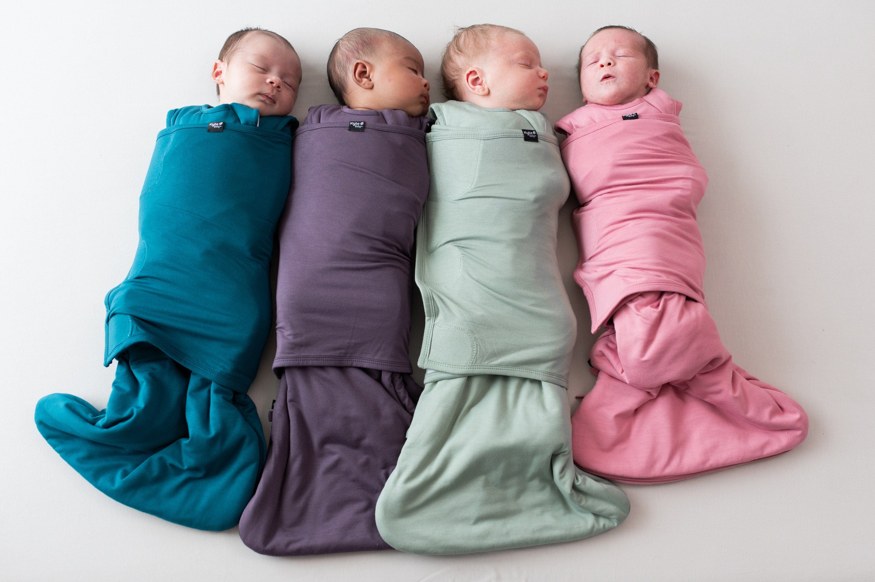 Infants shown swaddled in Sleep Bag Swaddlers in Fall 2024 colors