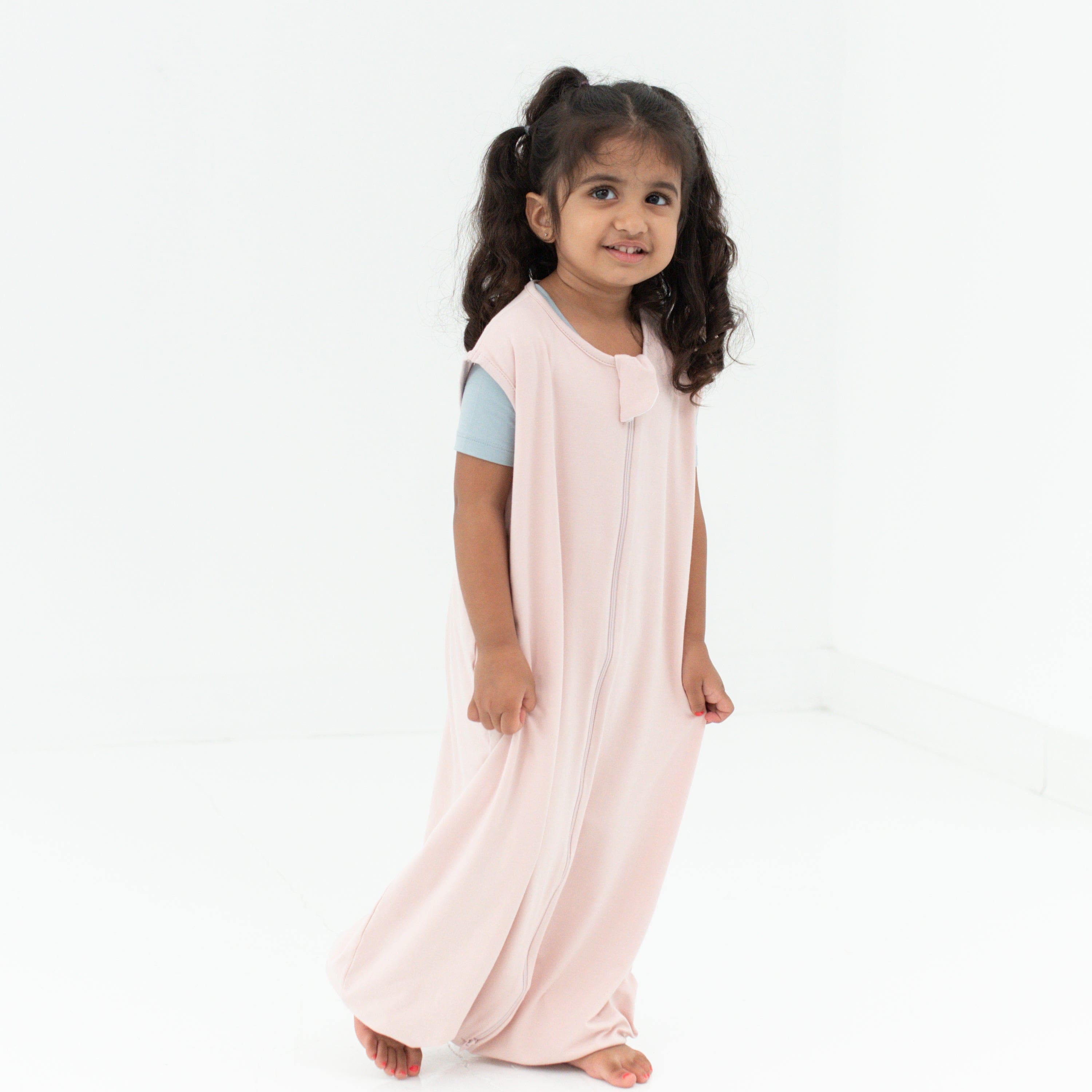 Young girl model wearing the Sleep Bag Walker in Blush 0.5