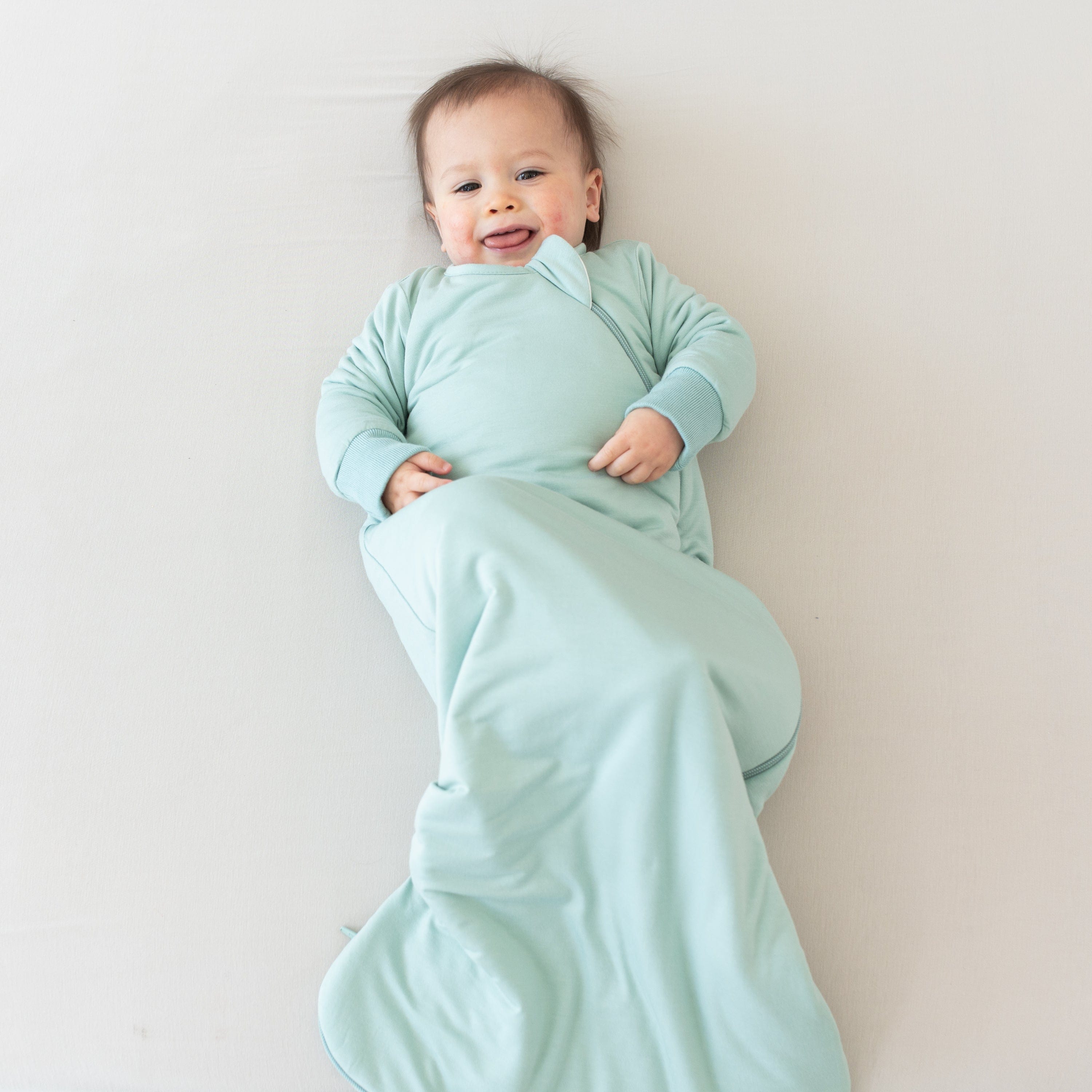 Baby in wearable blanket Kyte Baby Slumber Bag in Sage