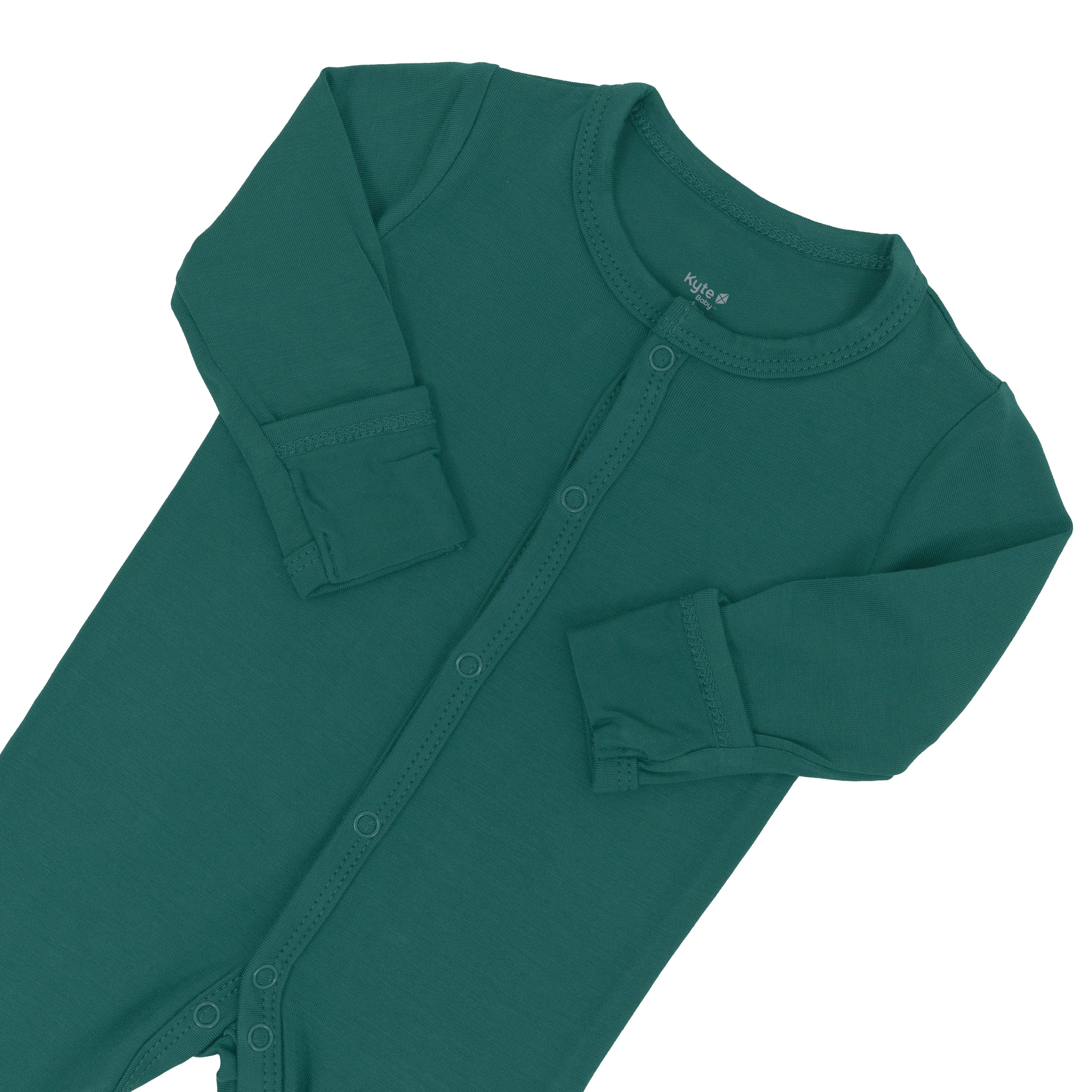 Foldover cuffs on Kyte Baby Footie in Emerald with arms folded inwards
