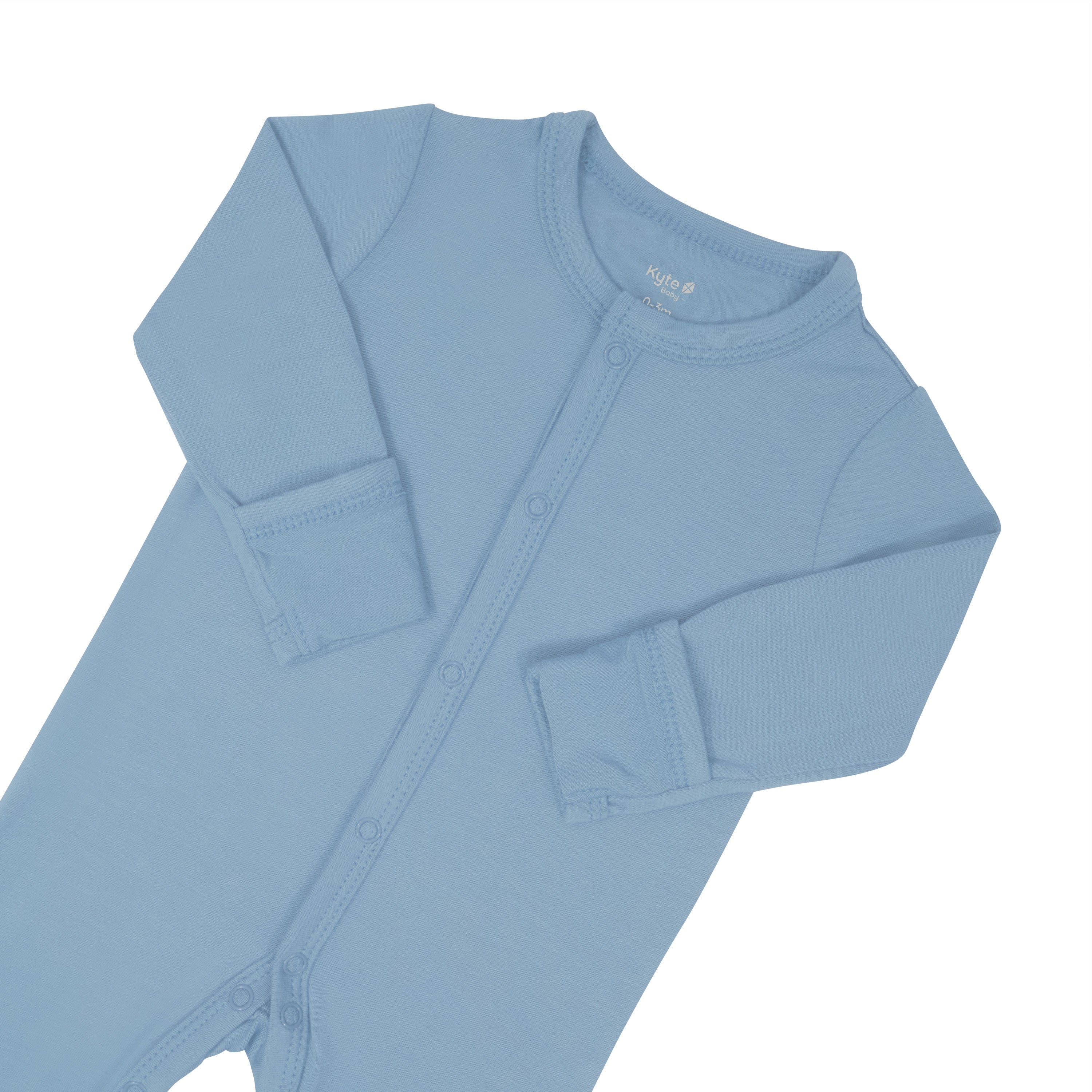 Fold-over cuffs on Kyte Baby Snap Footie in Slate with arms folded inwards