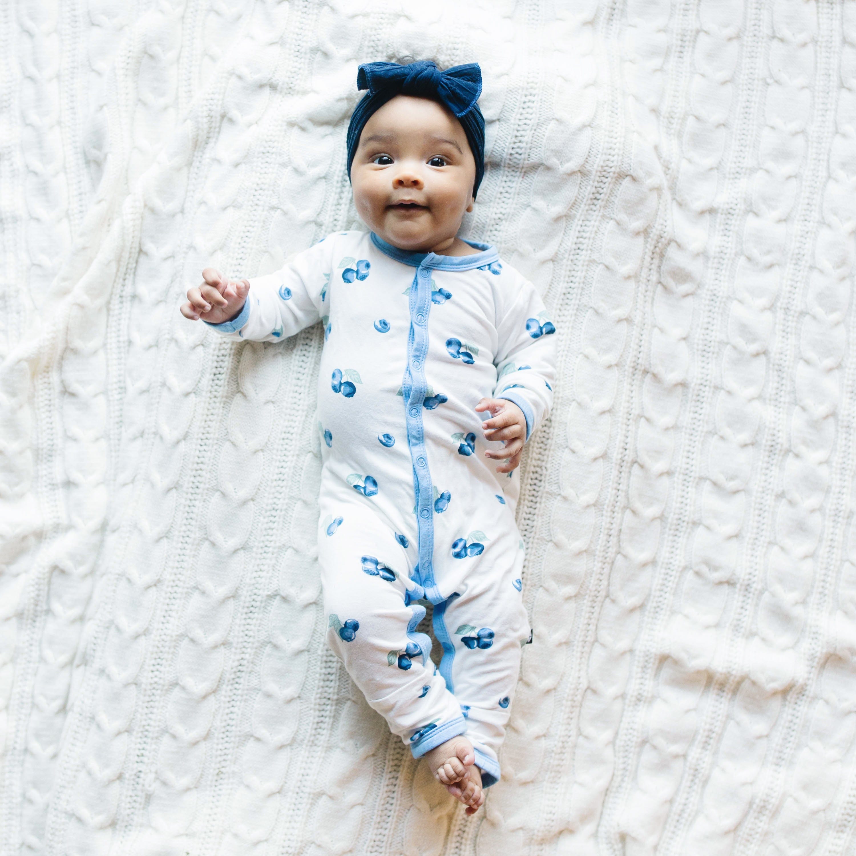 Infant wearing Kyte Baby Romper in Blueberry