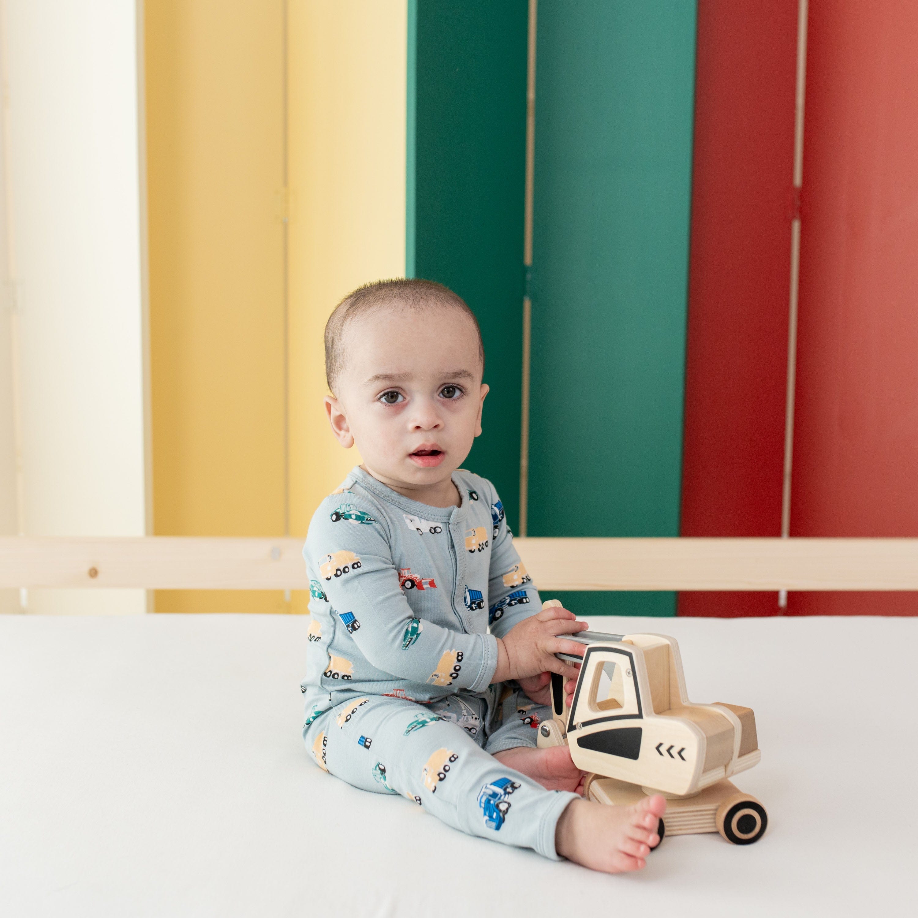 Infant wearing Kyte Baby Romper in Construction