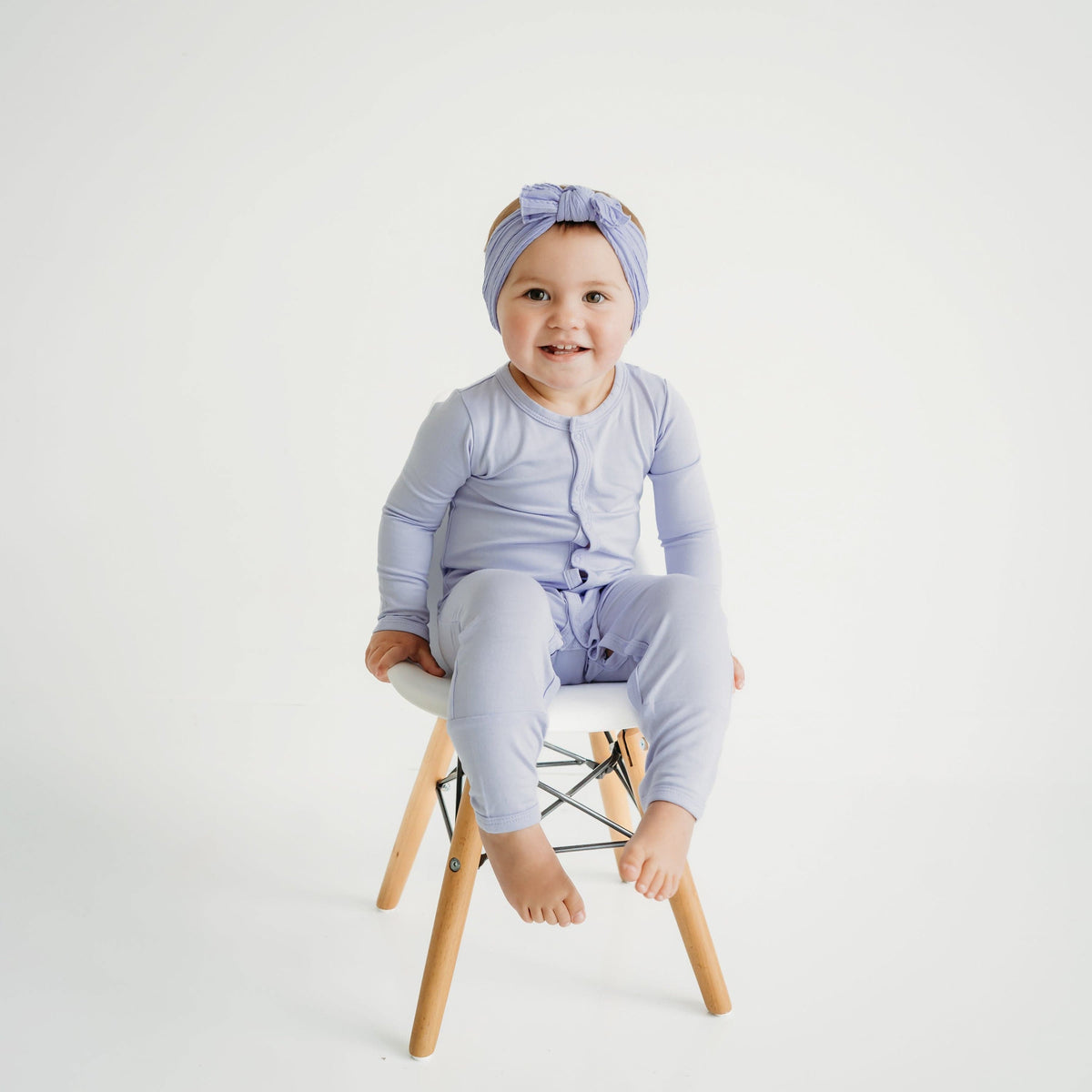 Toddler wearing Kyte Baby Romper in Lilac