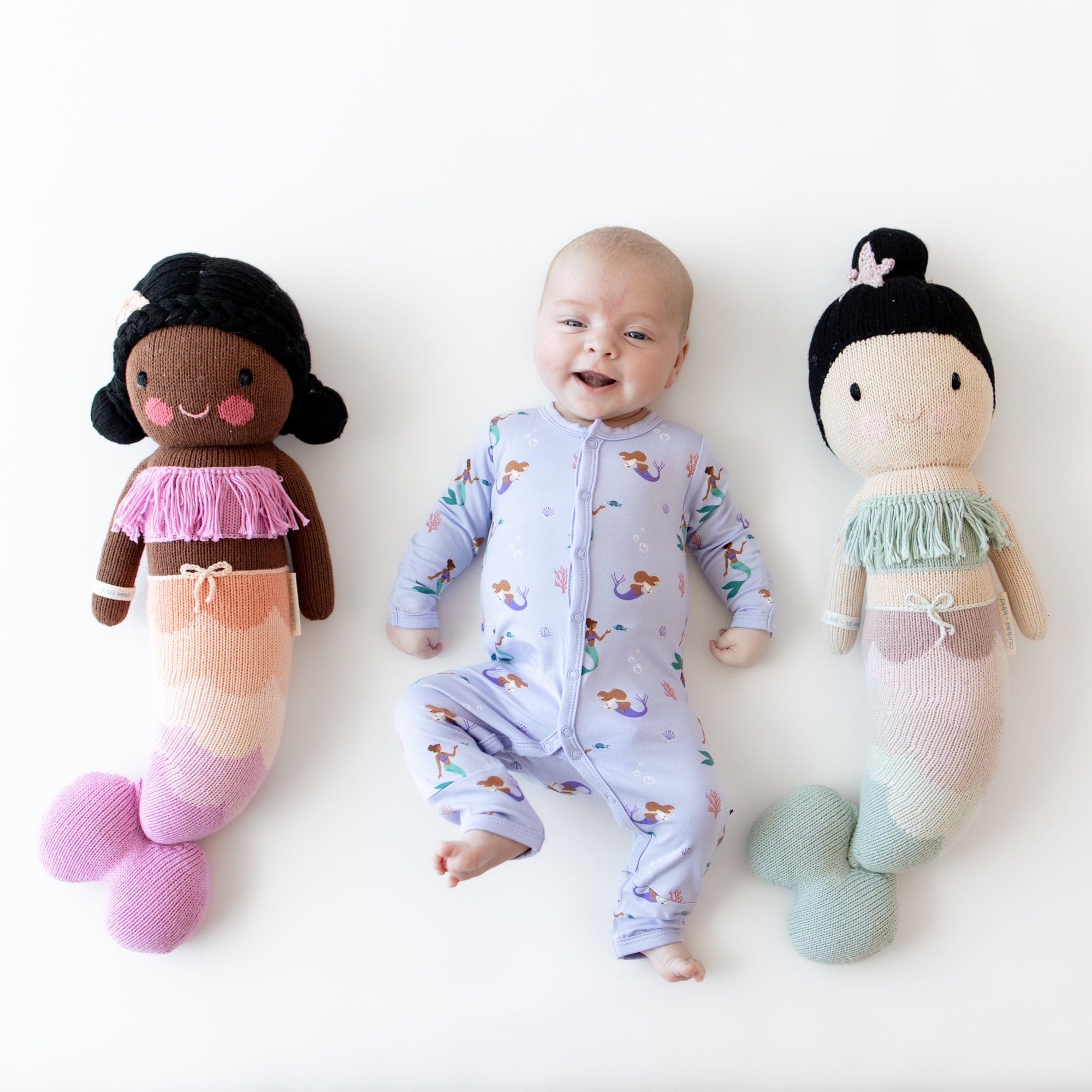 Newborn wearing long sleeve Kyte Baby Romper with snaps in Mermaid
