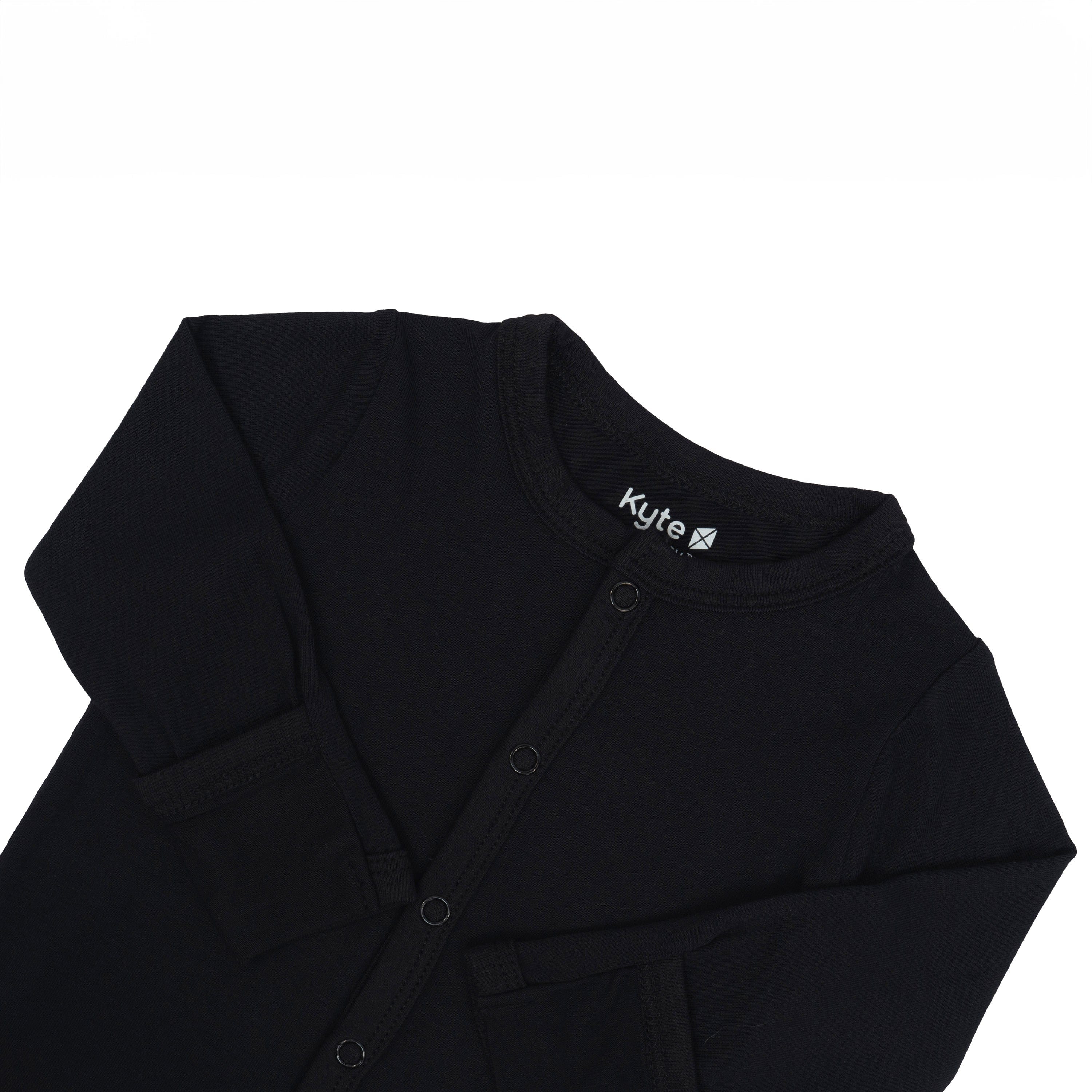 Fold-over cuffs on Kyte Baby Romper in Midnight with arms folded in