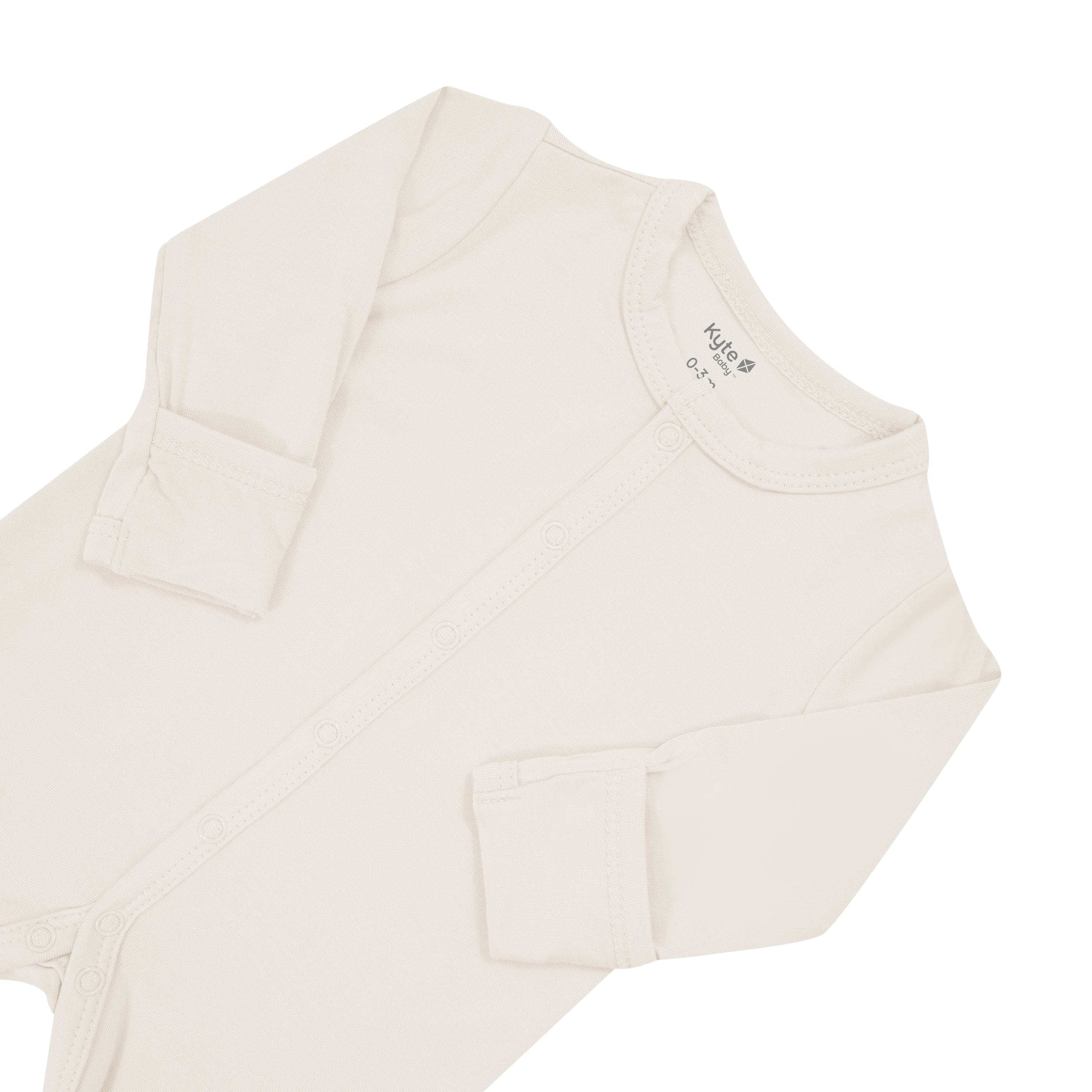 Close up of top portion of Kyte Baby long sleeve Romper in Oat