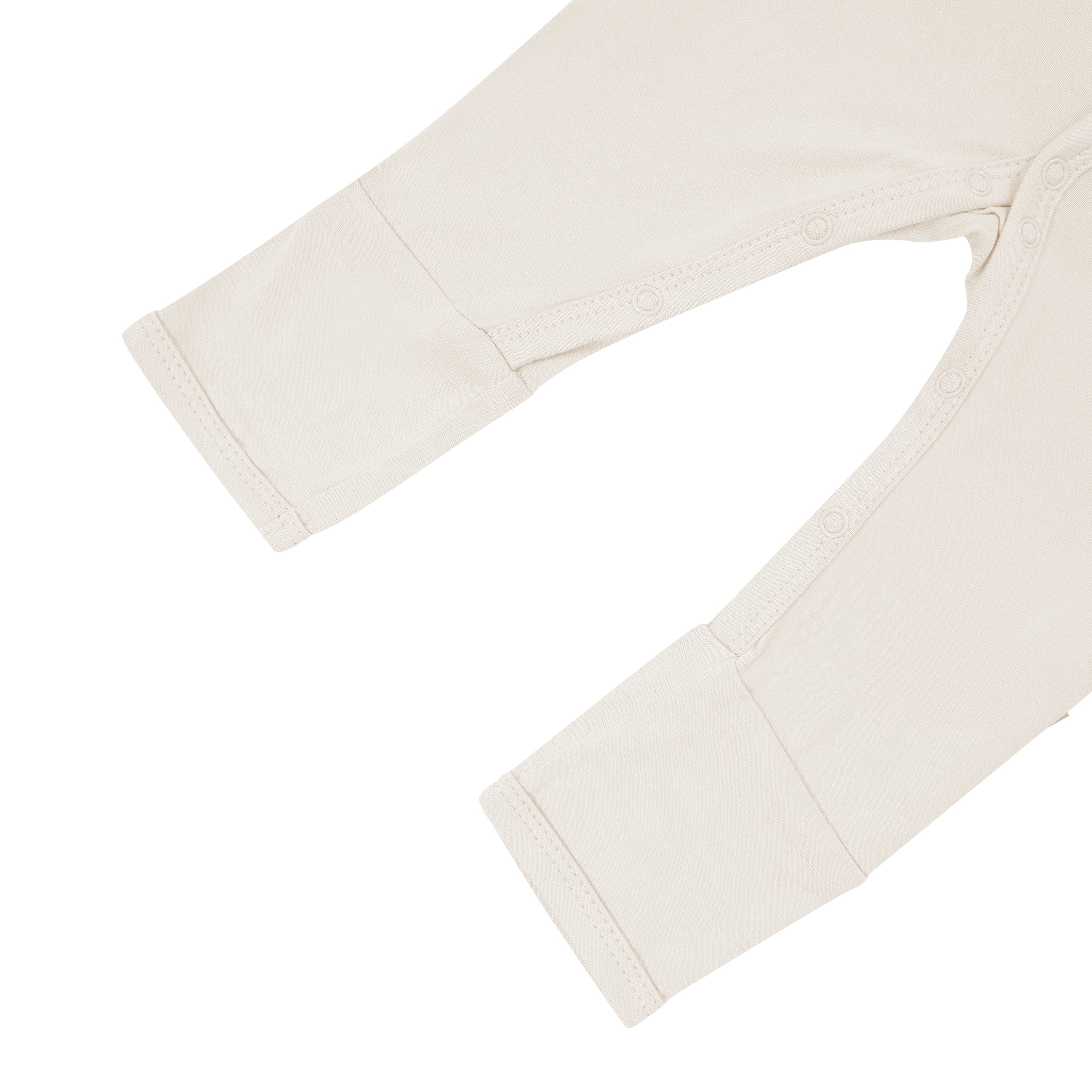 Snaps and legs on on Kyte Baby Romper in Oat