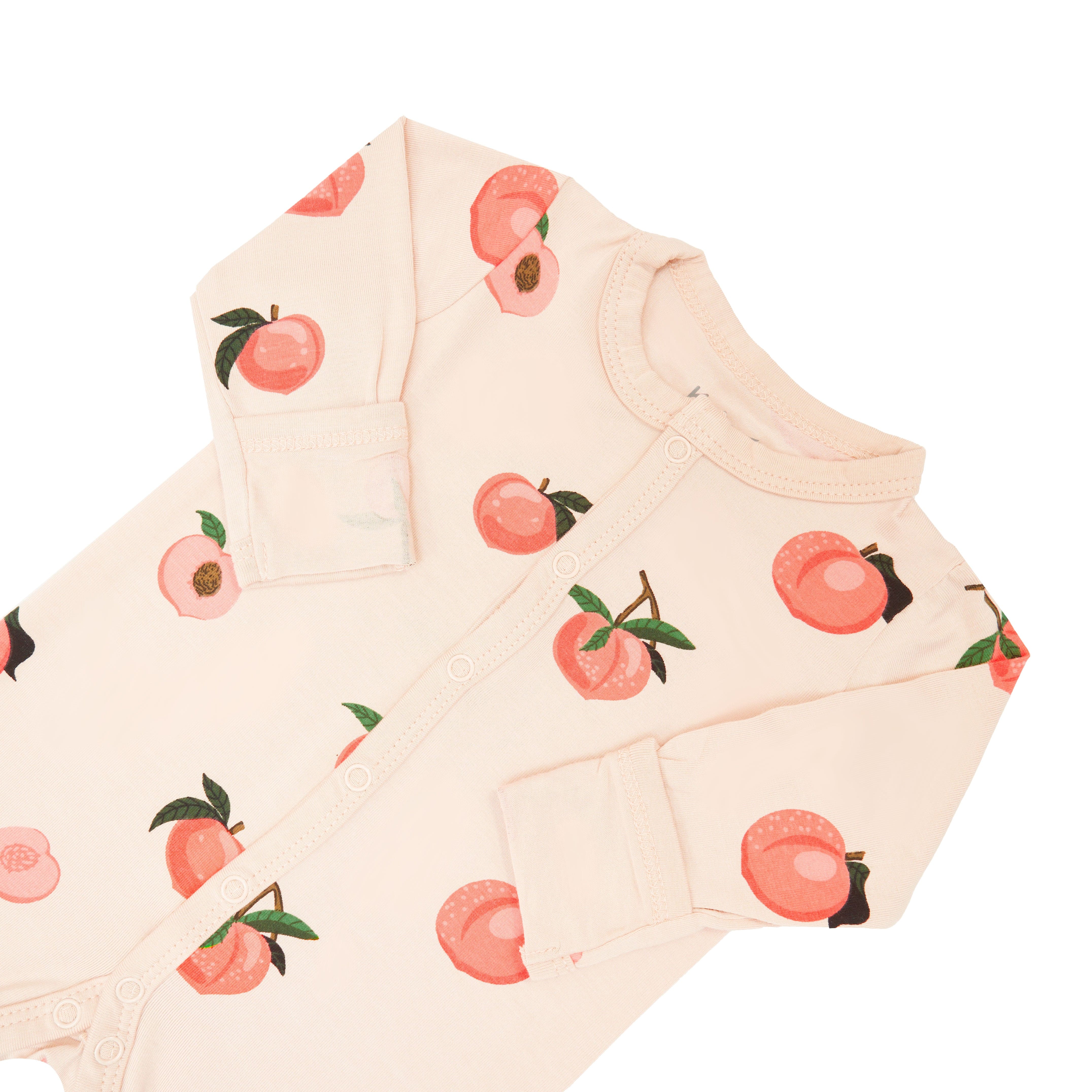 Fold-over cuffs on Kyte Baby long sleeve snap Romper in Peach
