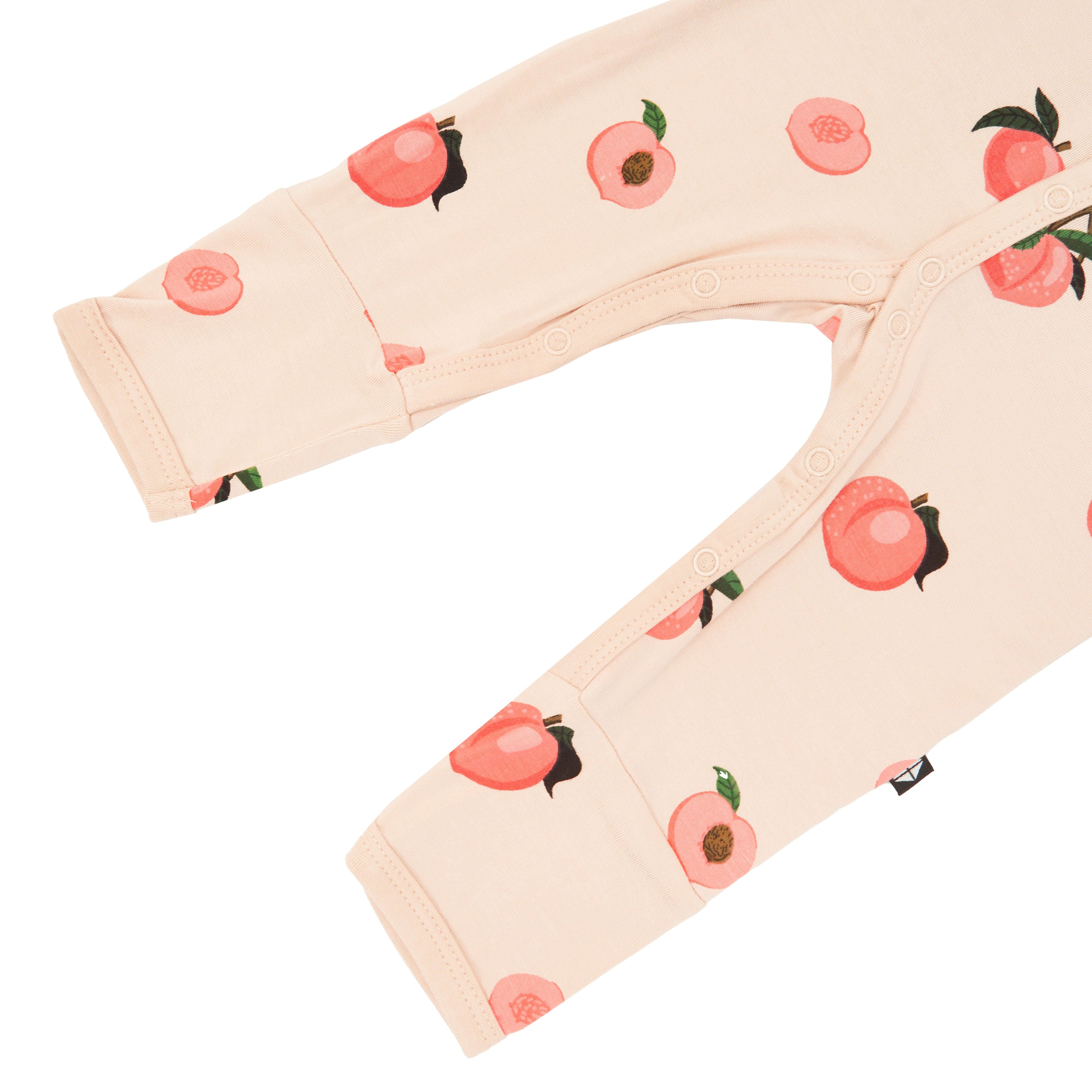 Leg opening on Kyte Baby long sleeve Romper in Peach