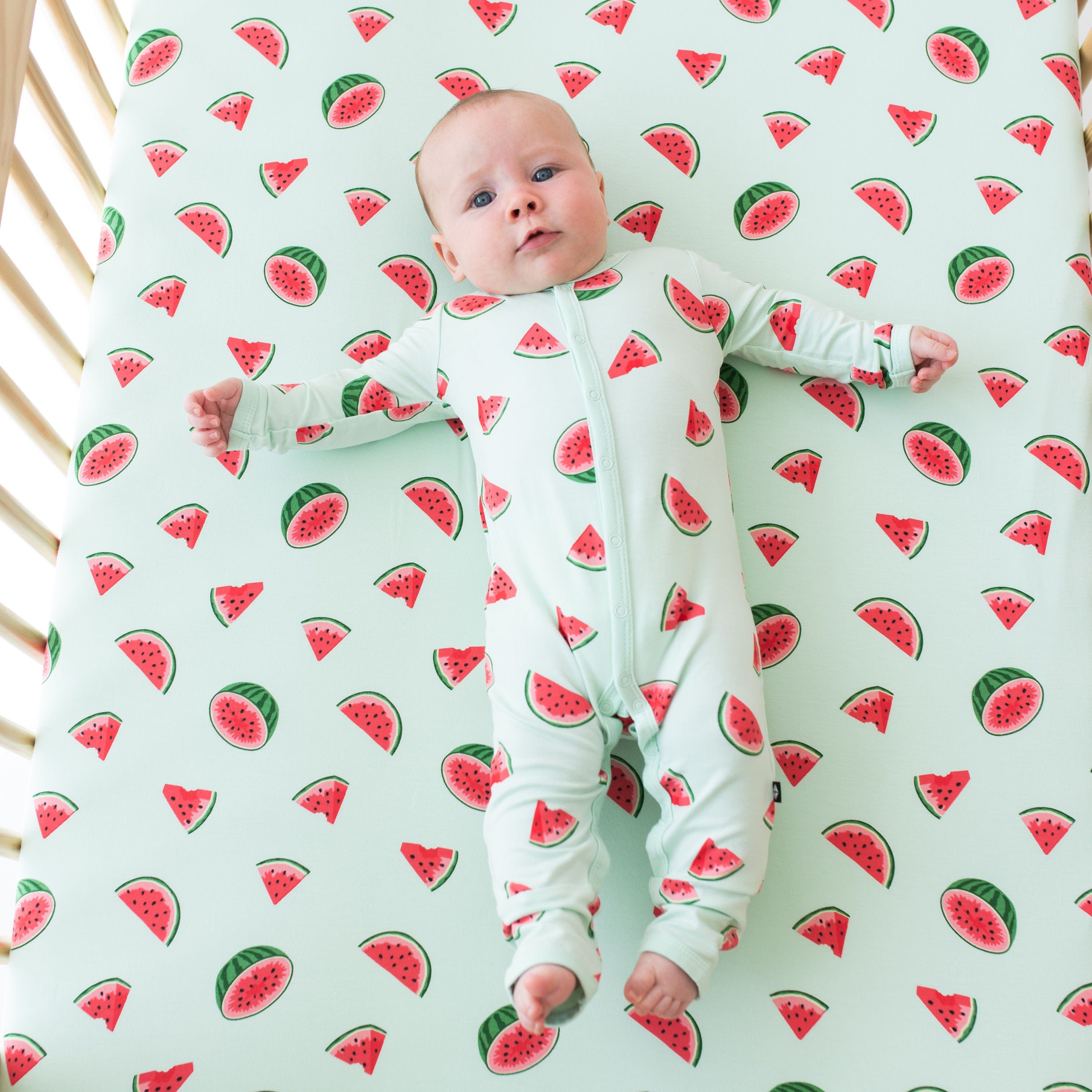 Infant wearing Kyte Baby Romper in Watermelon