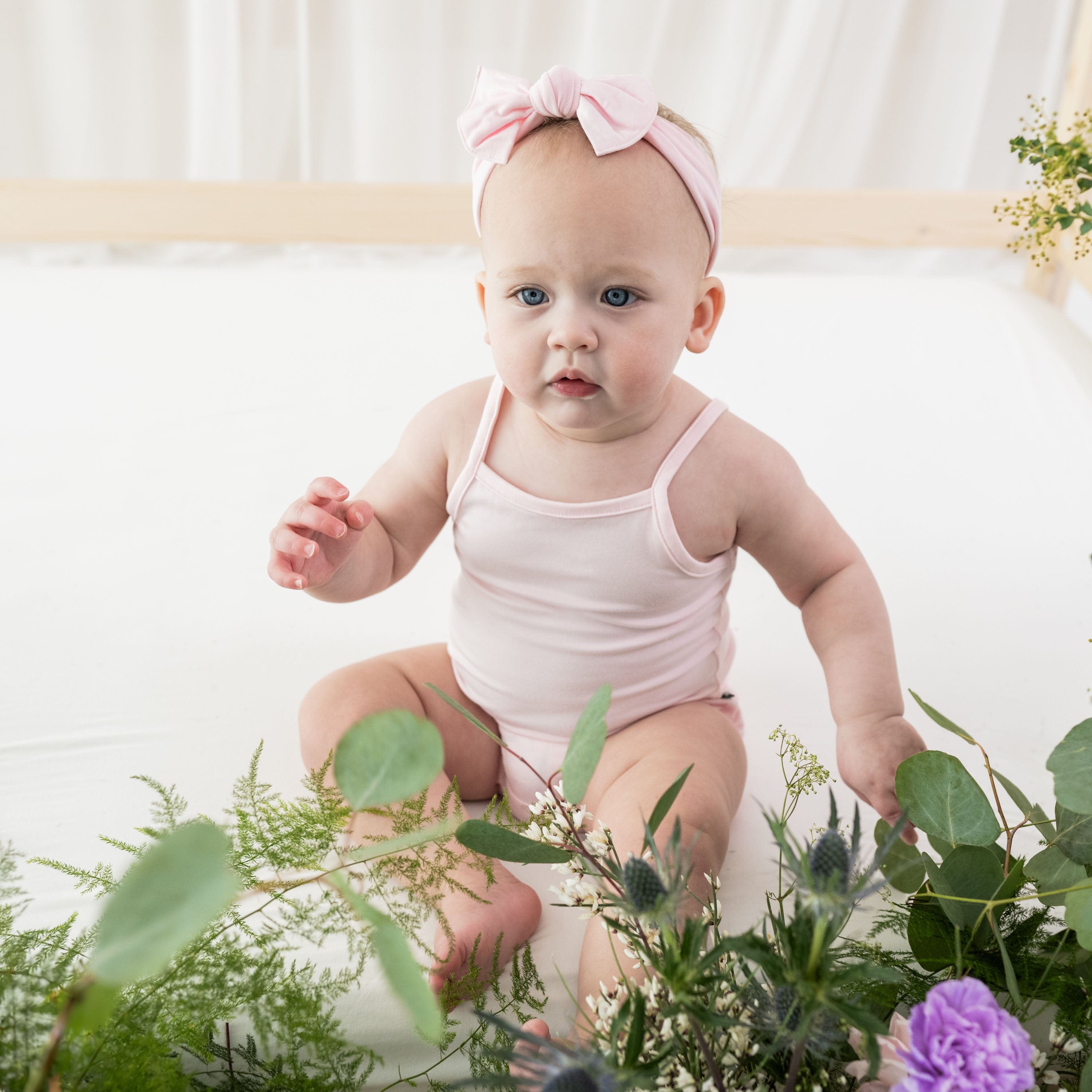 Infant wearing Kyte Baby bamboo Spaghetti Strap Leotard in Sakura