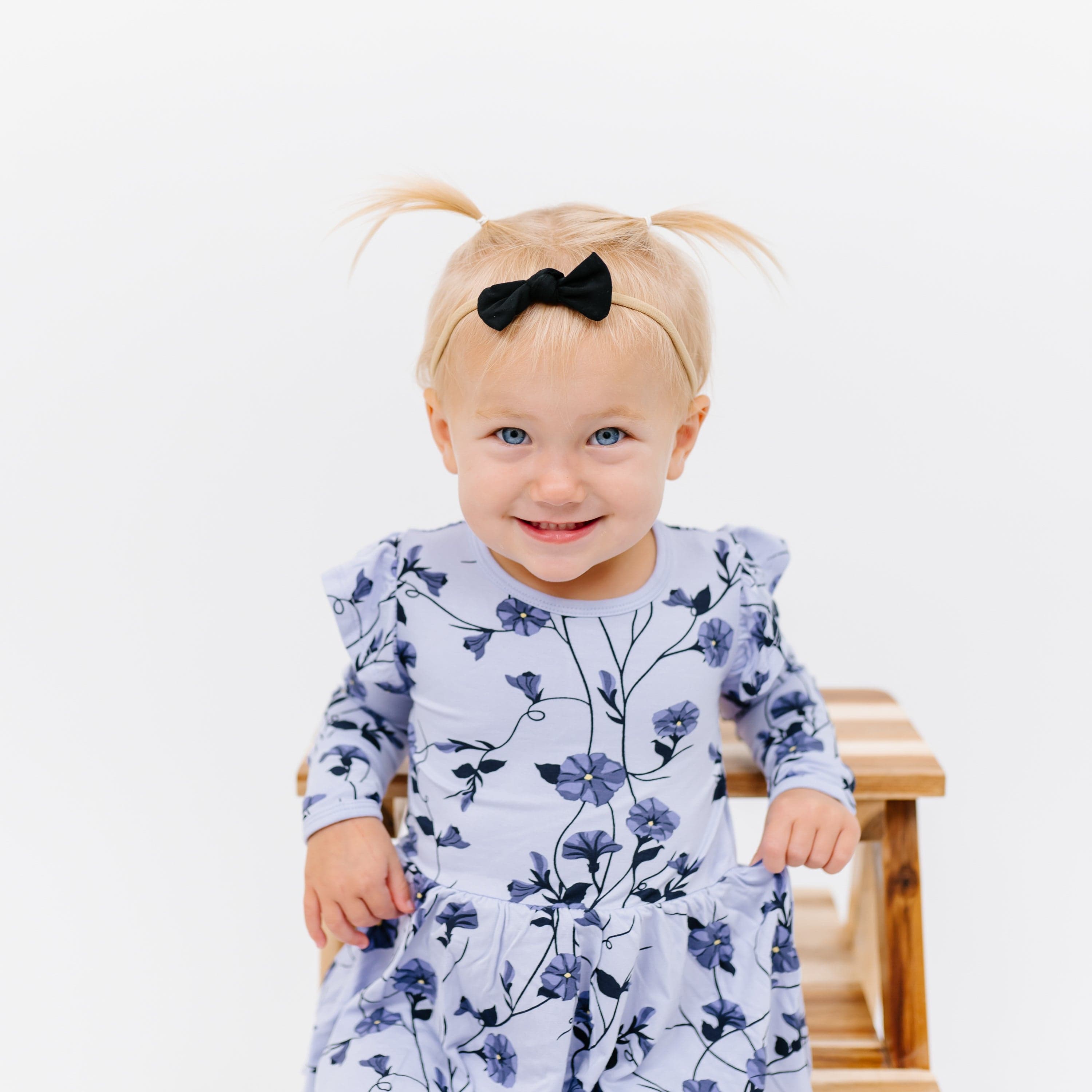 Toddler in pigtails wearing a Tiny Nylon Bow in Midnight