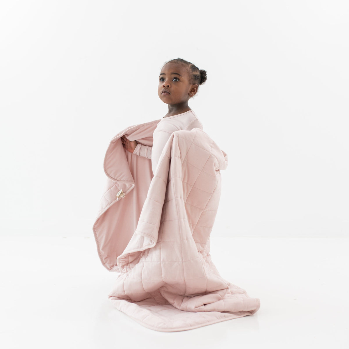 Standing toddler wrapped in a Toddler Blanket in Blush 1.0 TOG