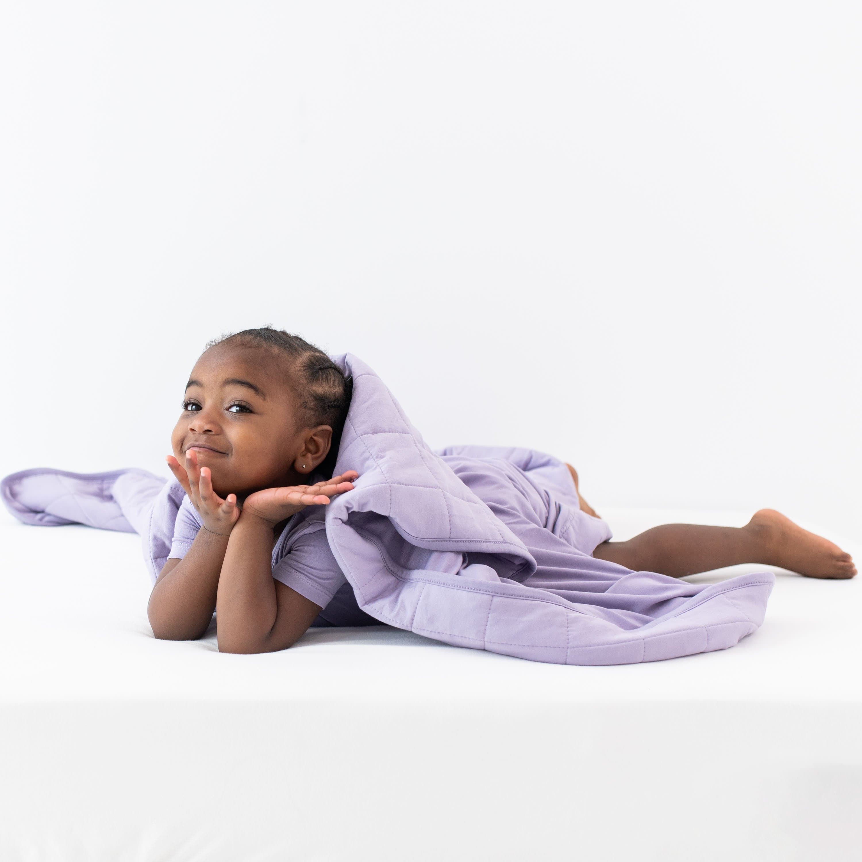 Child on tummy covered in a Toddler Blanket in Taro 2.5 TOG