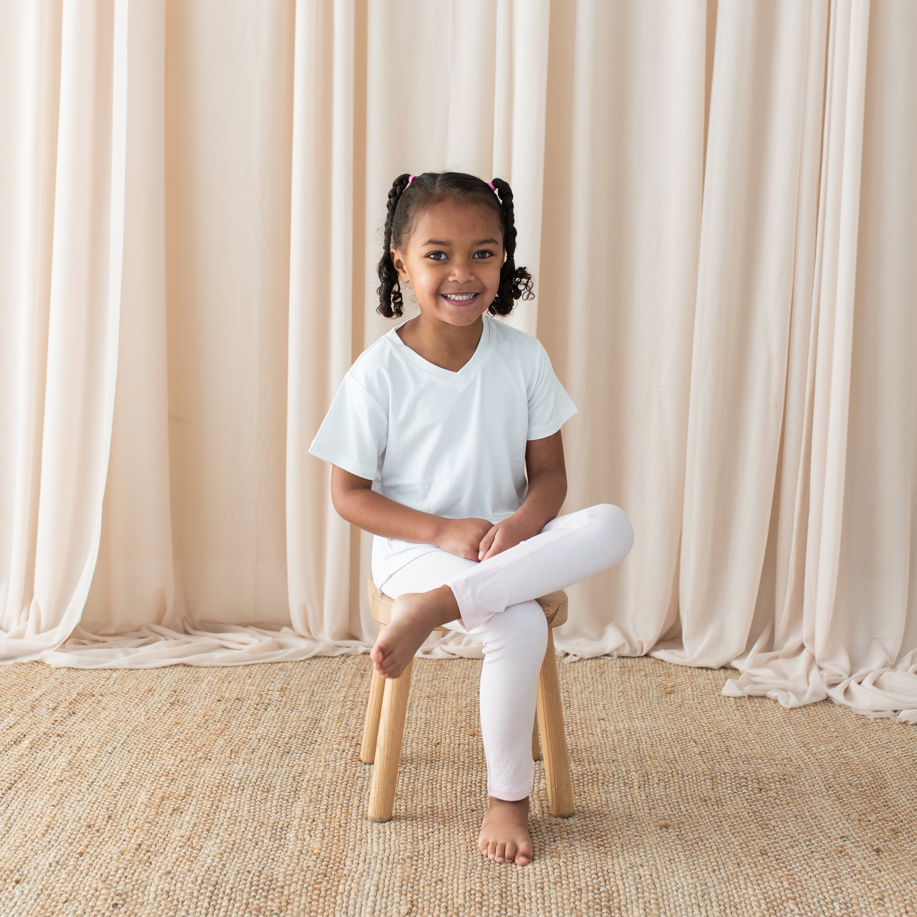 Girl wearing Kyte Baby bamboo Toddler Leggings in Sakura pink